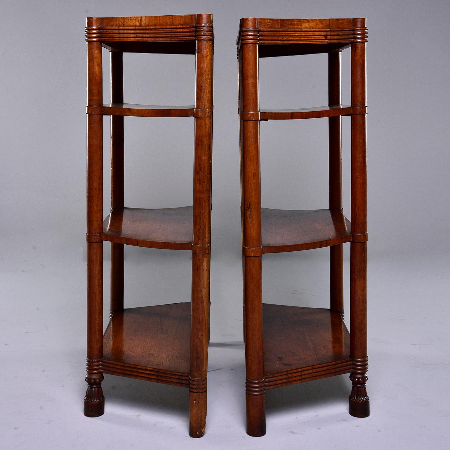 Pair of Italian freestanding shelf units made of wood with walnut veneer, circa 1920s. Shelves feature solid backs, decorative ridging on top and base, footed front legs and three shelves each with angled sides. Unknown maker. Sold and priced as a