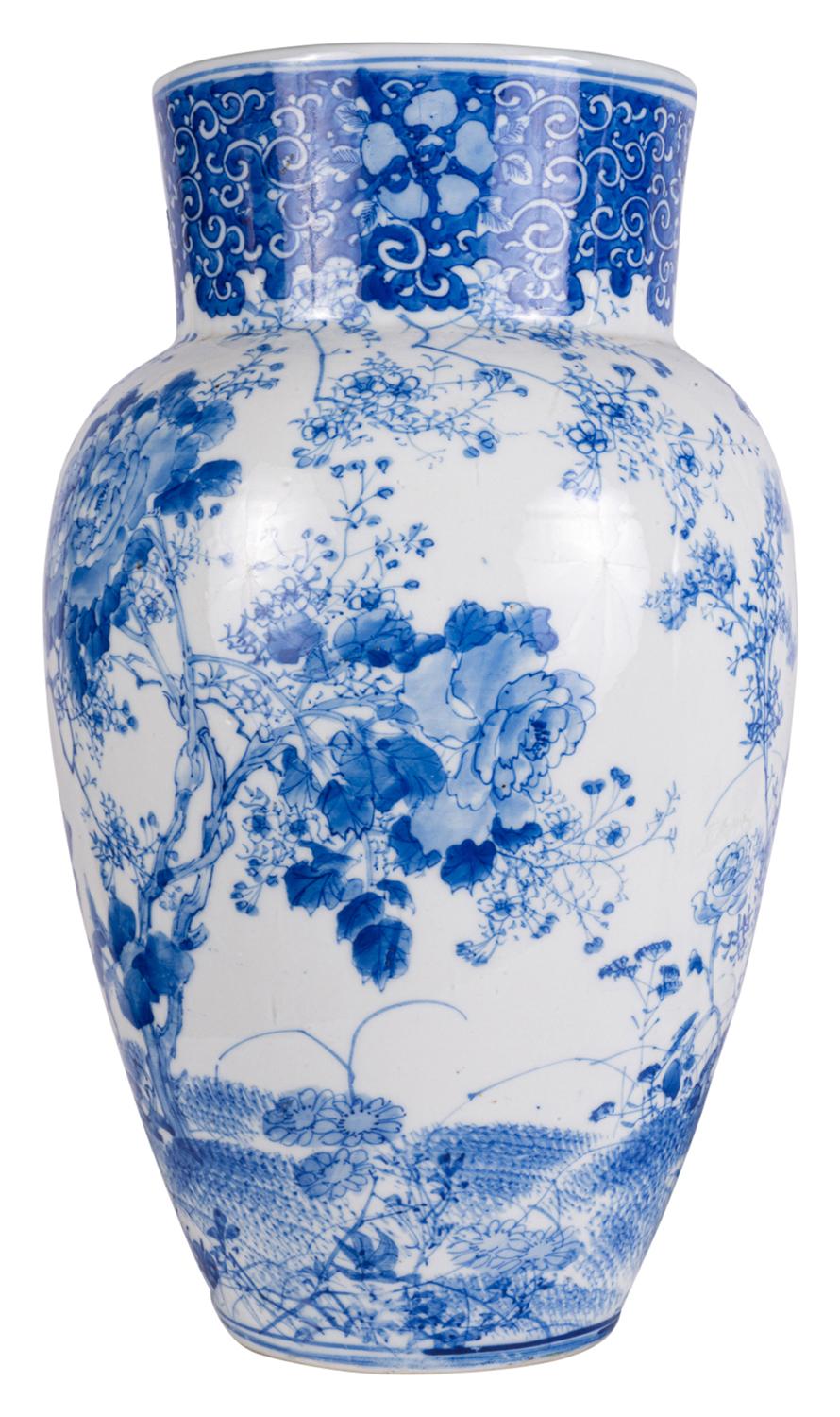 A fine quality pair of Japanese, Meiji period (1868-1912) blue and white vases, each with wonderful scenes of exotic birds in blossom trees.