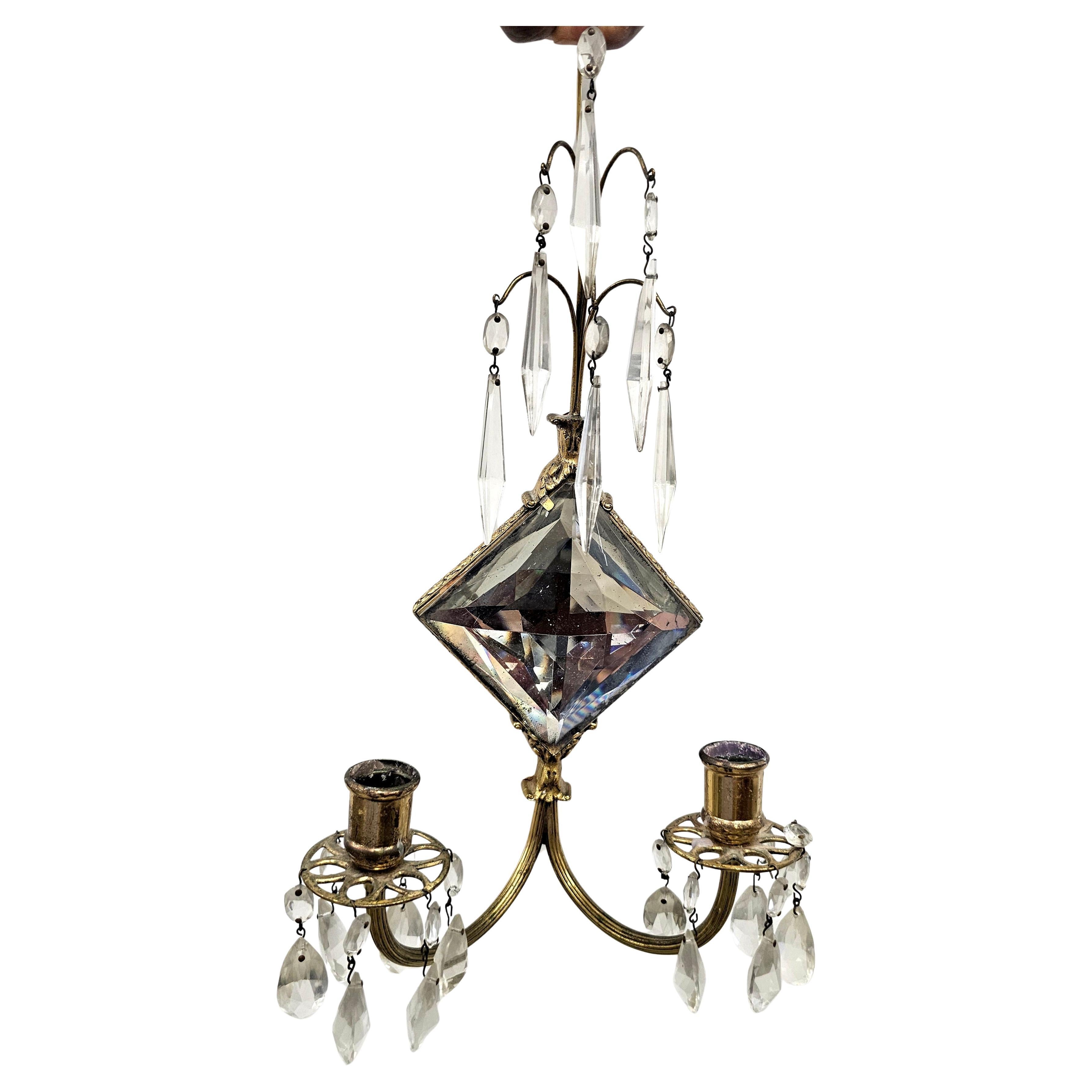 Paire Début du 20e siècle  Applique murale à deux lumières en cristal et laiton dans le style de Jules Leleu. A l'origine électrique, elle a été convertie en applique à bougies.
Mesure 9
