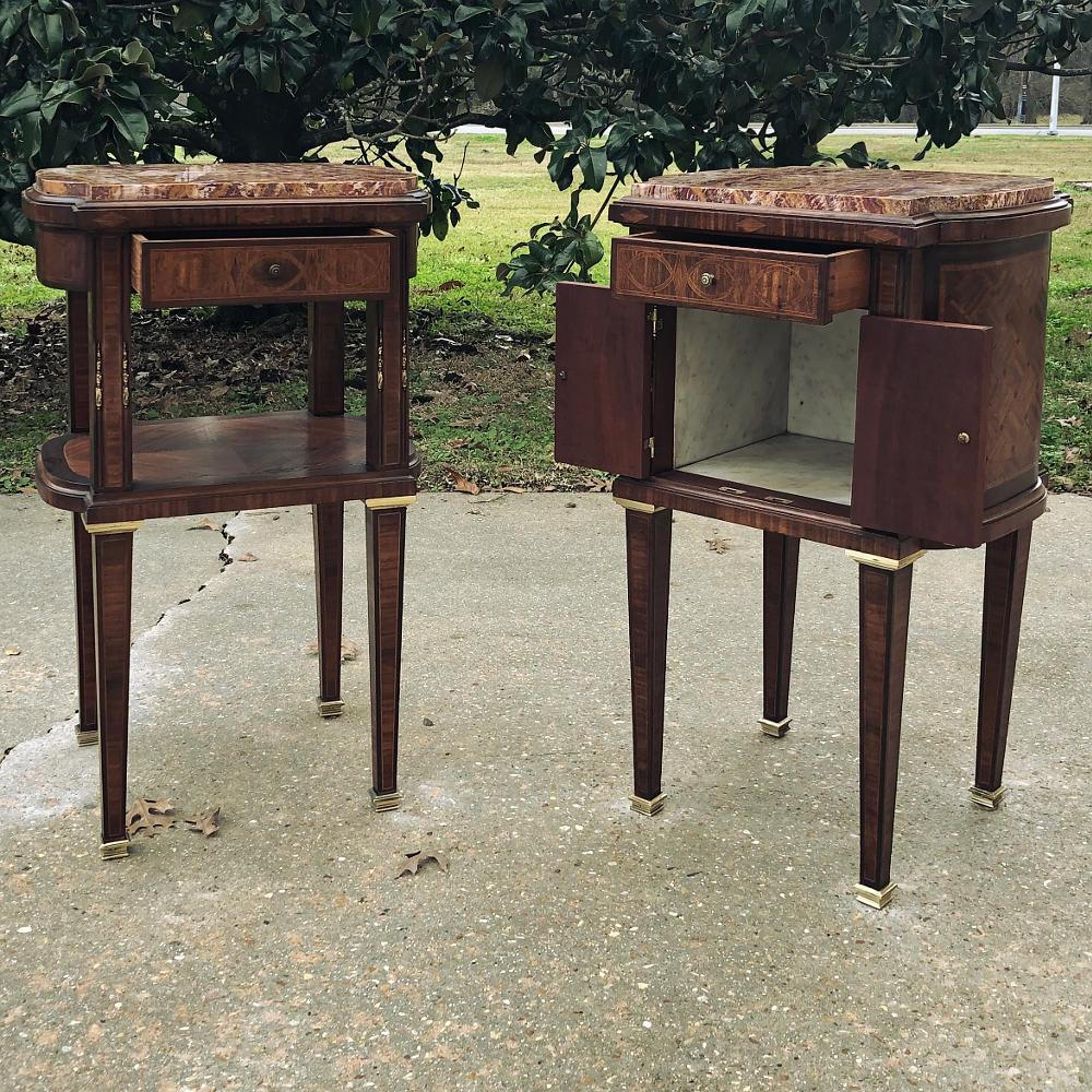 Pair of early Art Deco Period Louis XVI style rosewood inlaid nightstands with jasper tops are exceptionally unusual in a variety of ways! Larger than typical nightstands, they offer an exquisite surface on top cut from intricately veined jasper