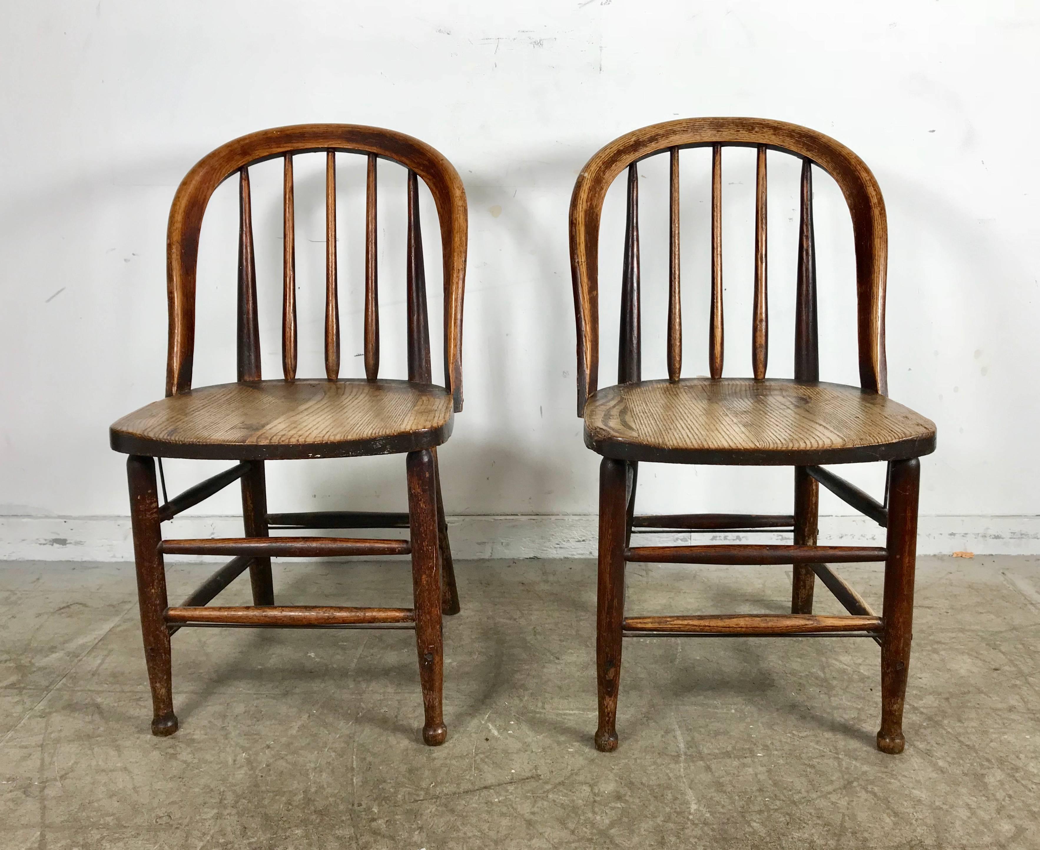 Pair of early oak antique industrial side chairs by Heywood Wakefield, solid oak construction, reinforced metal rod detailing, extremely comfortable. Retain original Heywood Wakefield label.