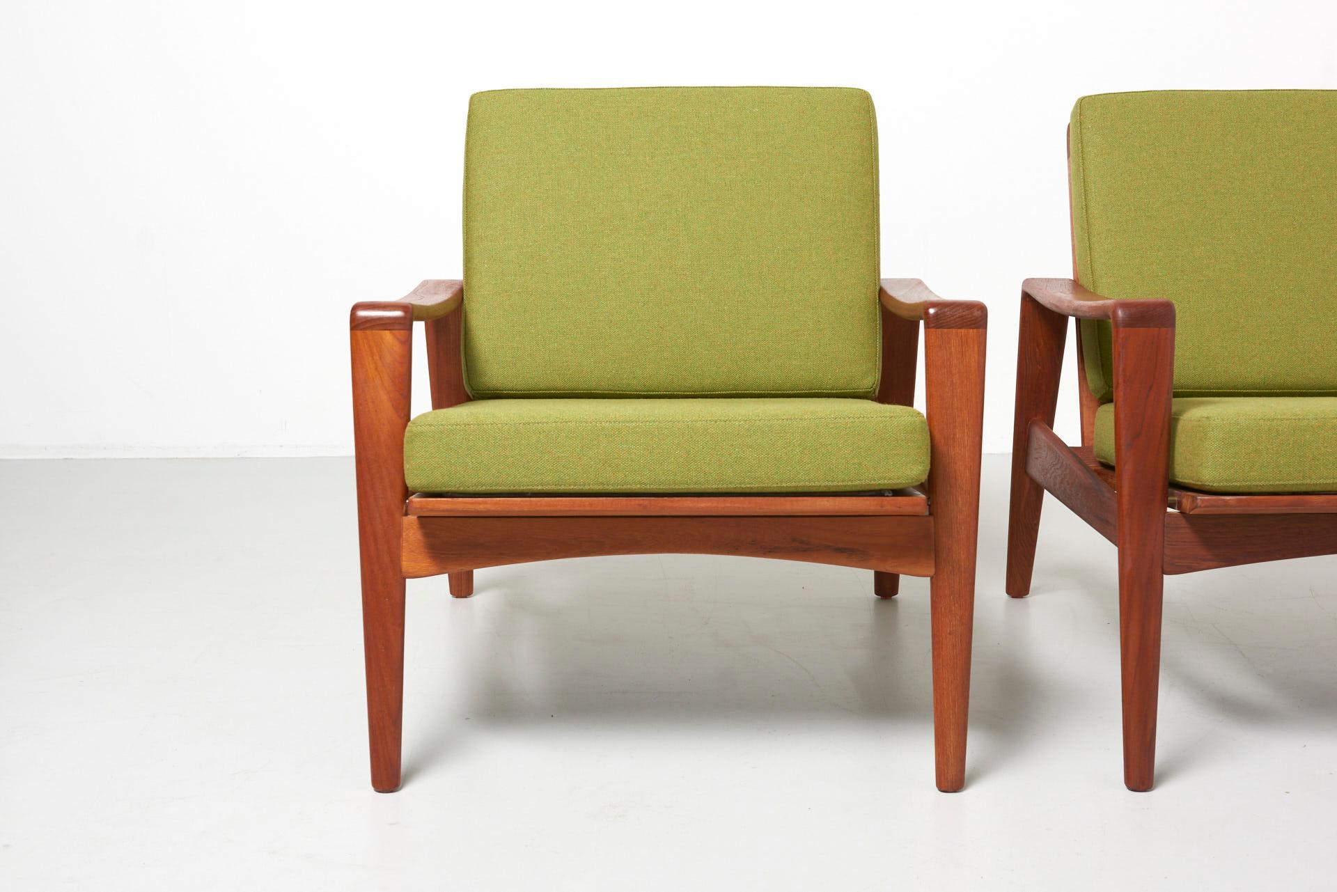 A pair easy chairs in teak with new cushions green wool fabric.
Design by Arne Wahl Iversen in the 1960s. Made in Denmark by Komfort.

 