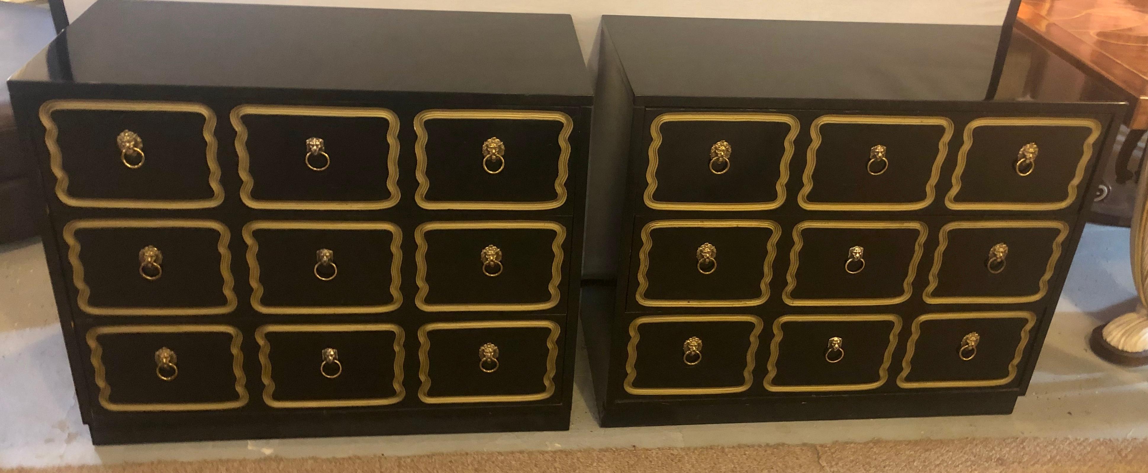 Pair of ebony dorothy draper style espana bachelor chests w/ 3 drawers. A pair of finely polished three drawer Espana Style Chests with Gilt Gold Decorated Drawer fronts and Lion Mask Drawer pulls.