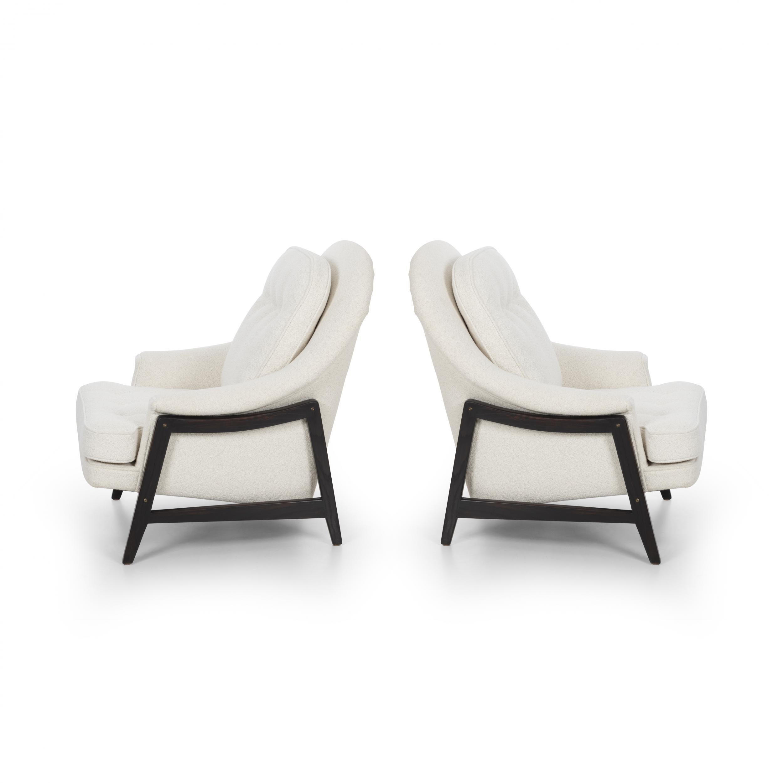 Pair of Edward Wormley Janus Collection lounge chairs and ottoman for Dunbar, model 5701 Walnut Frames with brass hardware, Reupholstered with Italian Boucle fabric. 
Label to underside Dunbar, Berne Indianna.