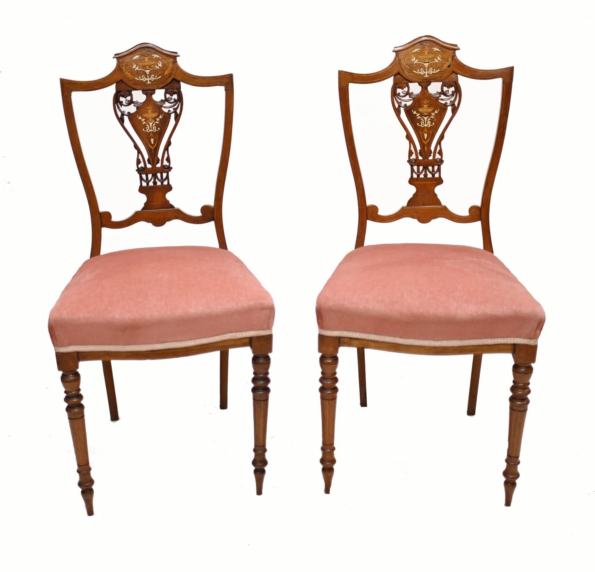 Quality pair of Edwardian inlayed hall chairs in mahogany
We date this lovely pair of accent chairs to circa 1910
Back rest - with shield back - features intricate inlay work including classical urns and floral motifs
Purchased from a private