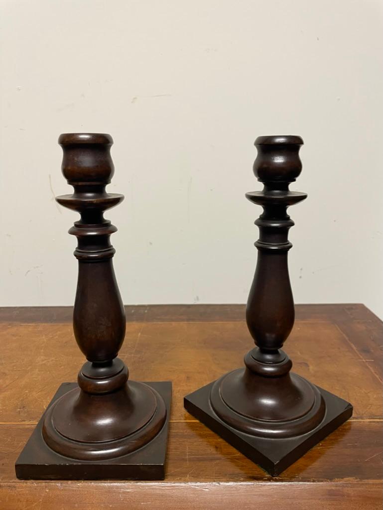 Pair of English Edwardian period hand turned mahogany candlesticks on square bases. Quite the charming pair, reasonably priced, will make a great gift. 
Measures: 9 inches high, 4 by 4 in wide 
Provenance: Phipps Family Estate, Long Island, NY.