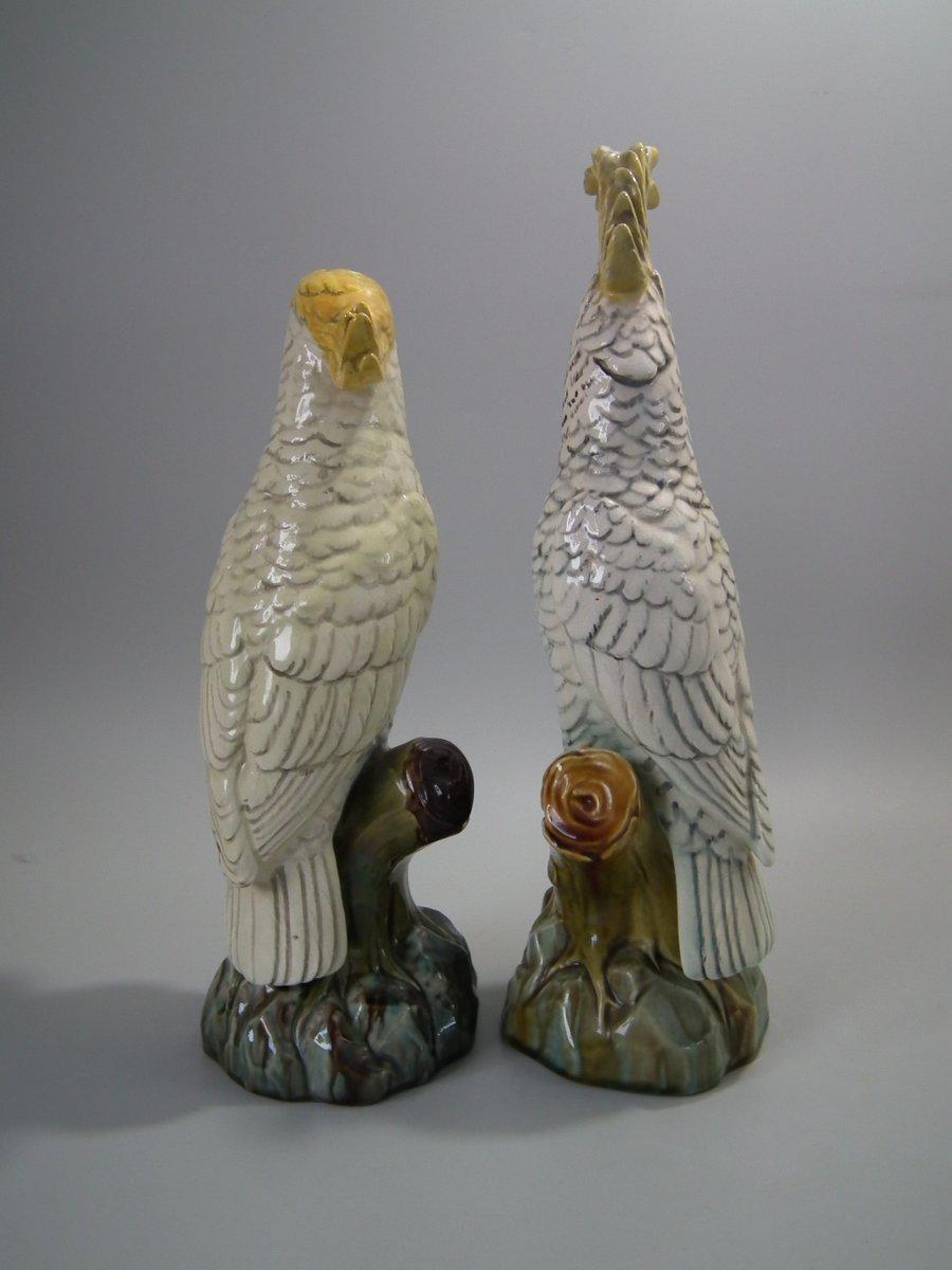 Pair of Mintons Majolica figures which feature cockatoos/parrots perched on a branch. White ground version. Colouration: white, ochre, green, are predominant. The piece bears maker's marks for the Mintons pottery. Bears a pattern number, '1846 /