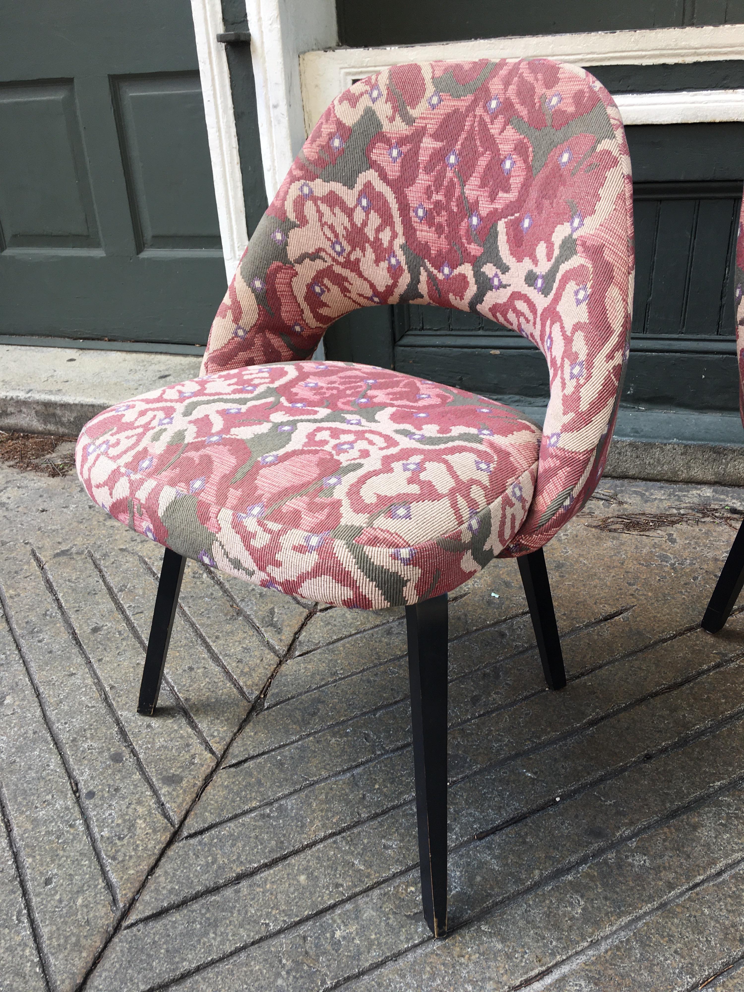 Pair of Eero Saarinen for Knoll executive side chairs with wooden legs. Legs were painted black at some point in their life, can still see the very early Knoll label. Chairs are solid and sort of fun with the floral Fabric! Use as is or reupholster!