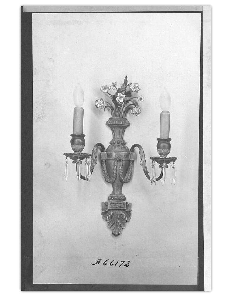 Pair of two-arm wall lights with green patina in the neoclassical style by Edward F. Caldwell. With sockets and wiring, ready for installation. See our image from the Caldwell archives at the Smithsonian.