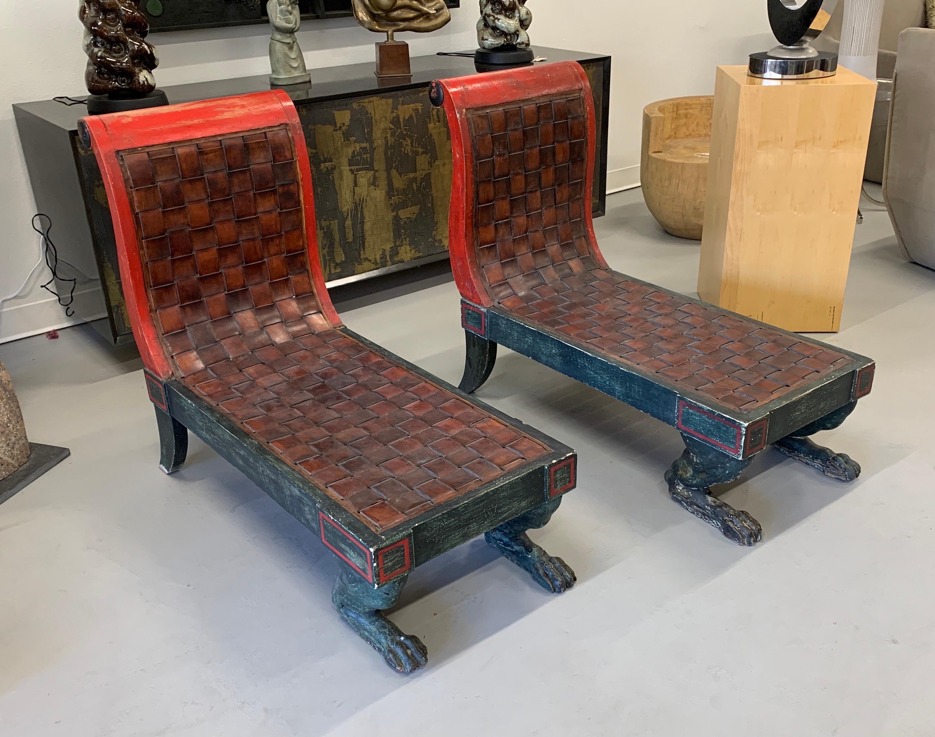 A pair of Egyptian Revival painted Lion or paw foot wood front feet with woven leather. These are likely made by Hendrix and Allardyce, a California design firm, in the late 1990s or early 2000s. The paint has just the right amount of wear giving