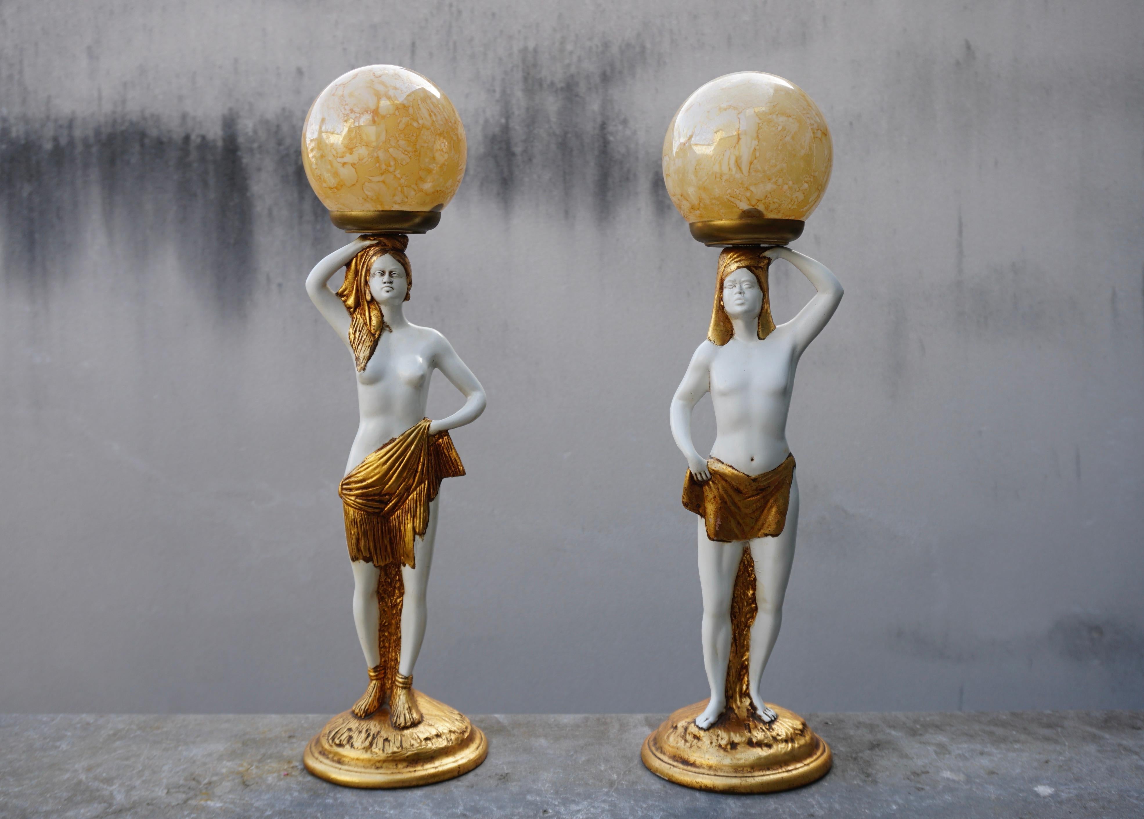 Pair of beautiful white table lamps from an Egyptian couple with glass shades.

Height 23.2