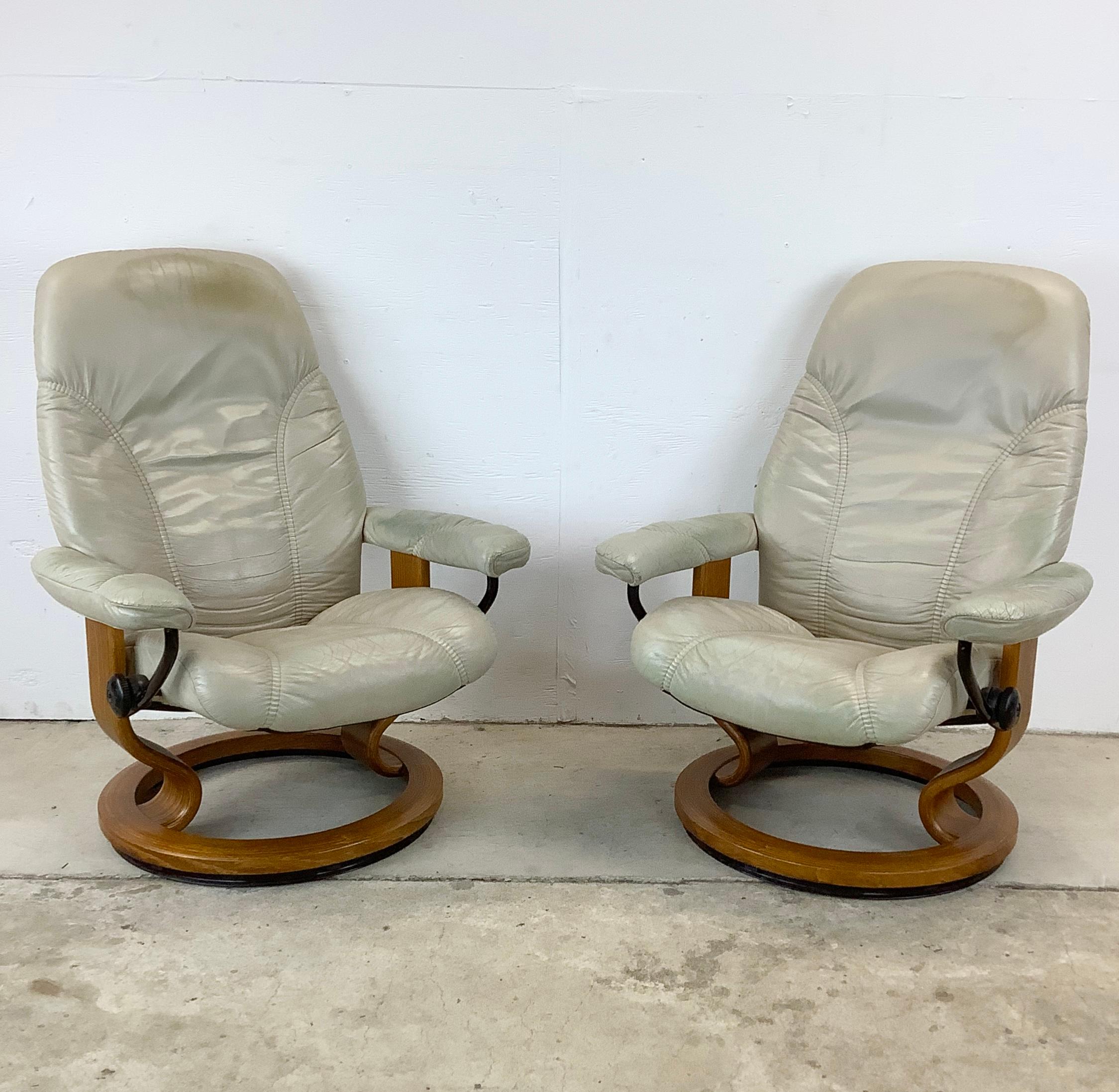 Step into a world of unrivaled comfort with this pair of Ekornes Stressless Reclining Lounge Chairs, paired with matching ottomans, where Norwegian craftsmanship meets the functional elegance of mid-century design. These sets, with their off-white