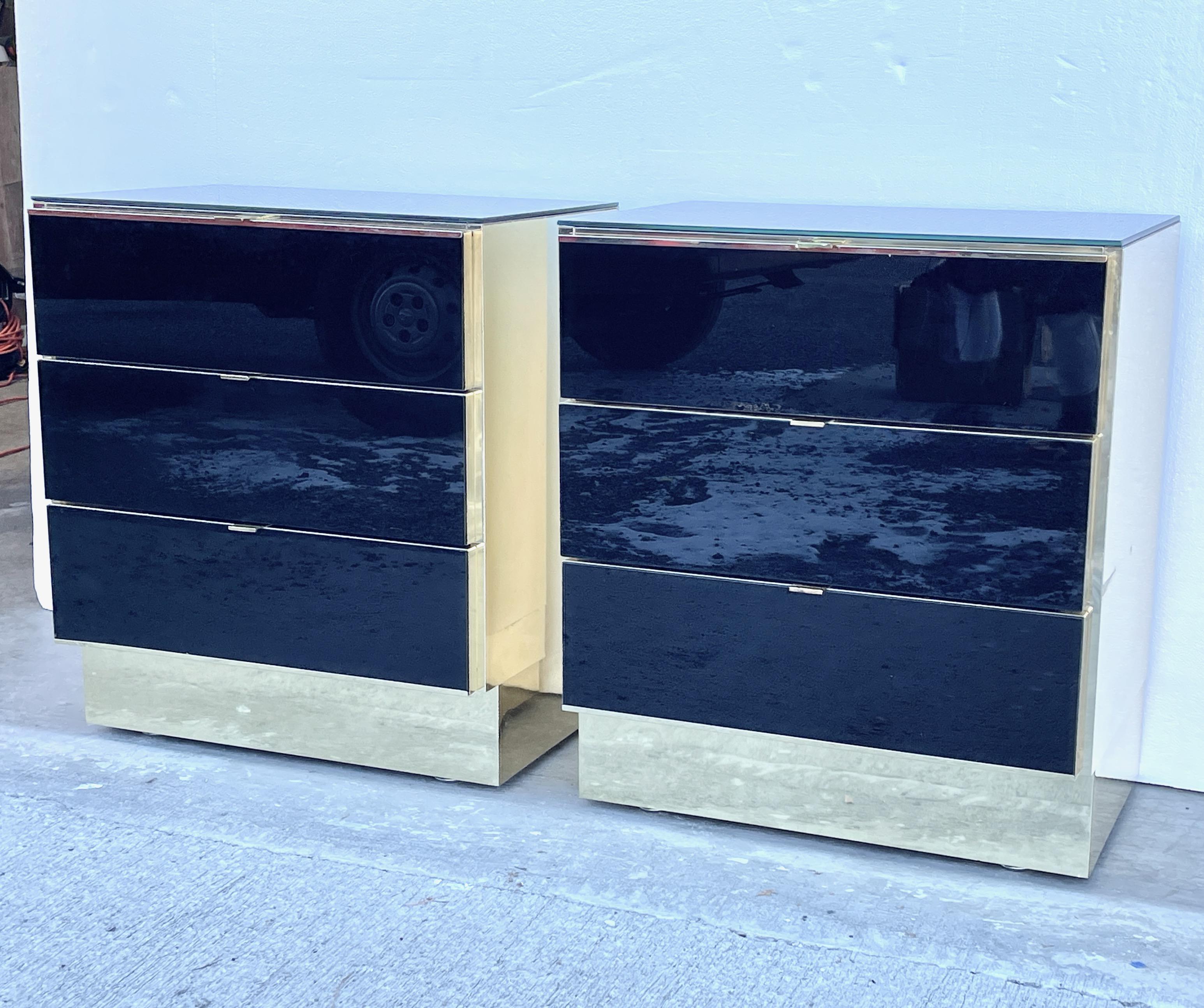 Pair of glamorous O. B. Solie for Ello Furniture brass case with black glass fronts three drawer chests.
Proportions make these suitable as nightstands as well.
