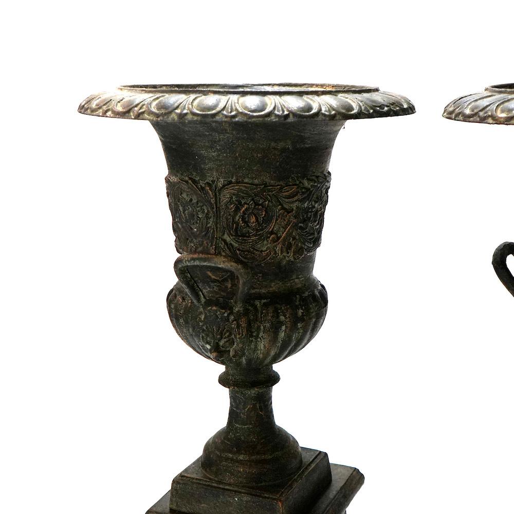 20th Century Pair Embossed Cast Iron Classical Double Handled Garden Urns on Plinths, 20th C