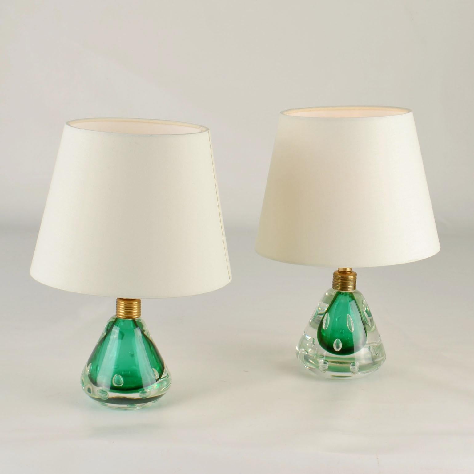 Pair of green Murano glass Sommerso table lamps, produced by using the technique '' Bullicante, '' into a cone shaped mold thick glass is applied then over laying air bubbles within the wall. The lamps were designed by Seguso Dalla Venezia, & C.