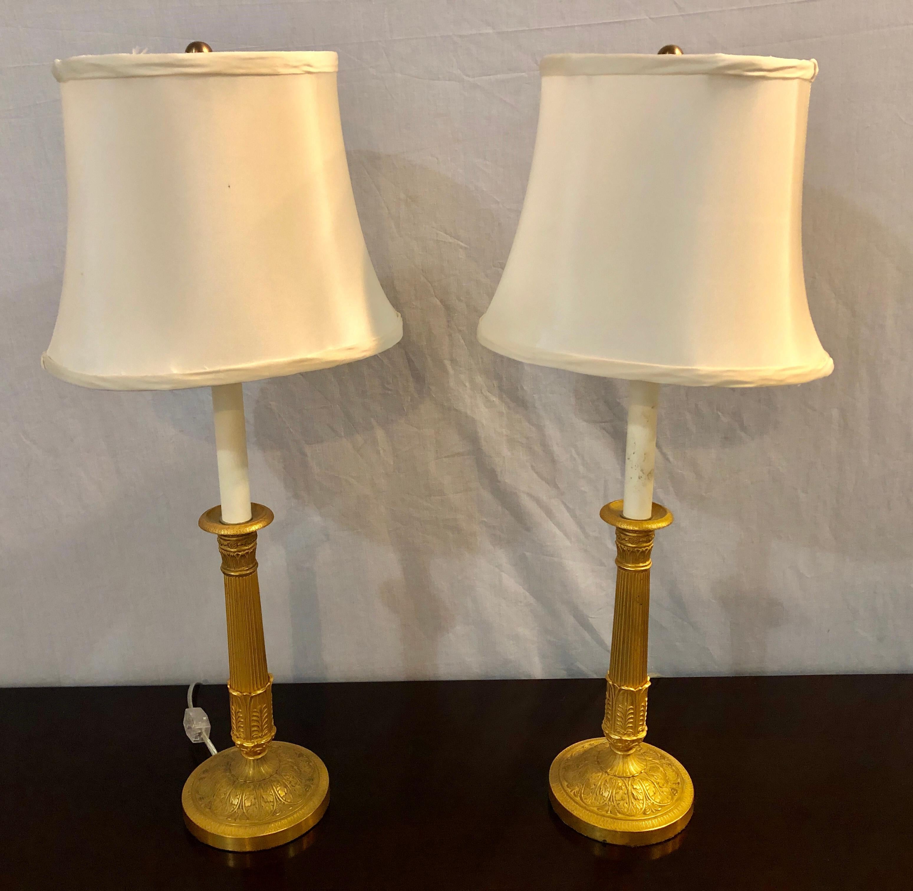 Quality abounds on this fine pair of Empire bronze candleprick late 19th century table lamps with custom silk Diane Studio engraved shades. These finely crafted dore bronze tables lamps take one bulb.

Shades: 8 inches high, 10.5 inches diameter.