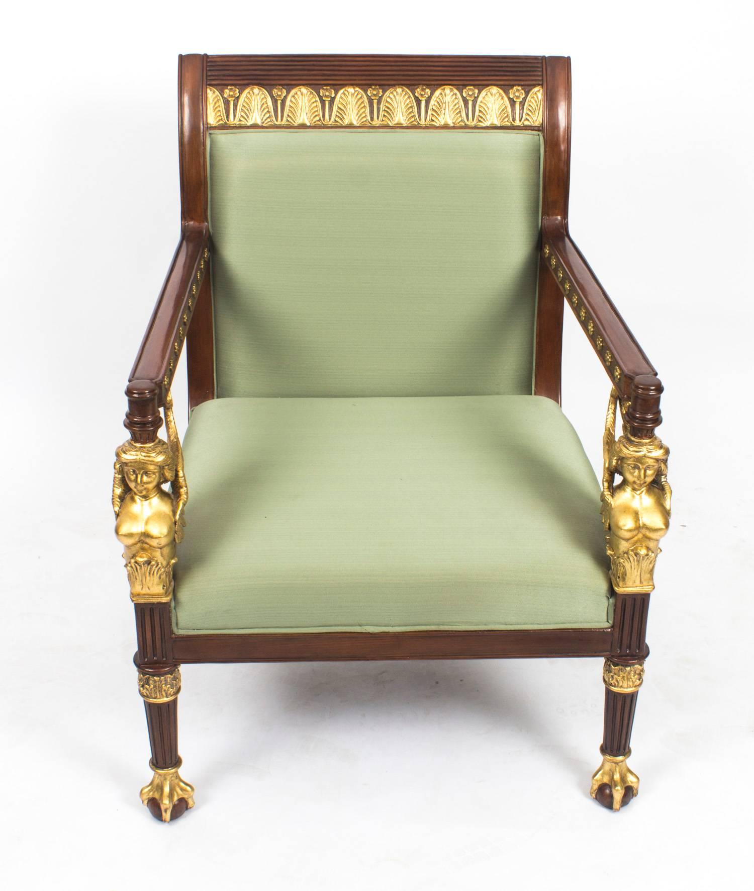 This is a beautiful pair of Empire Revival mahogany and giltwood armchairs which date from the late 20th century. 

They are made of mahogany that is beautiful in color and the back rail features a carved reeded top with decorative giltwood