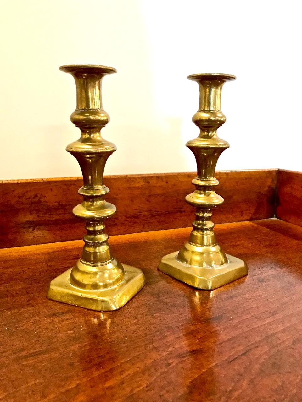 This is the second of two pairs of English Victorian brass Push-Up candlesticks. These sticks are in overall very good condition having acquired a warm natural patina and retaining their original iron push-ups. The bases are a bit uneven; the sticks