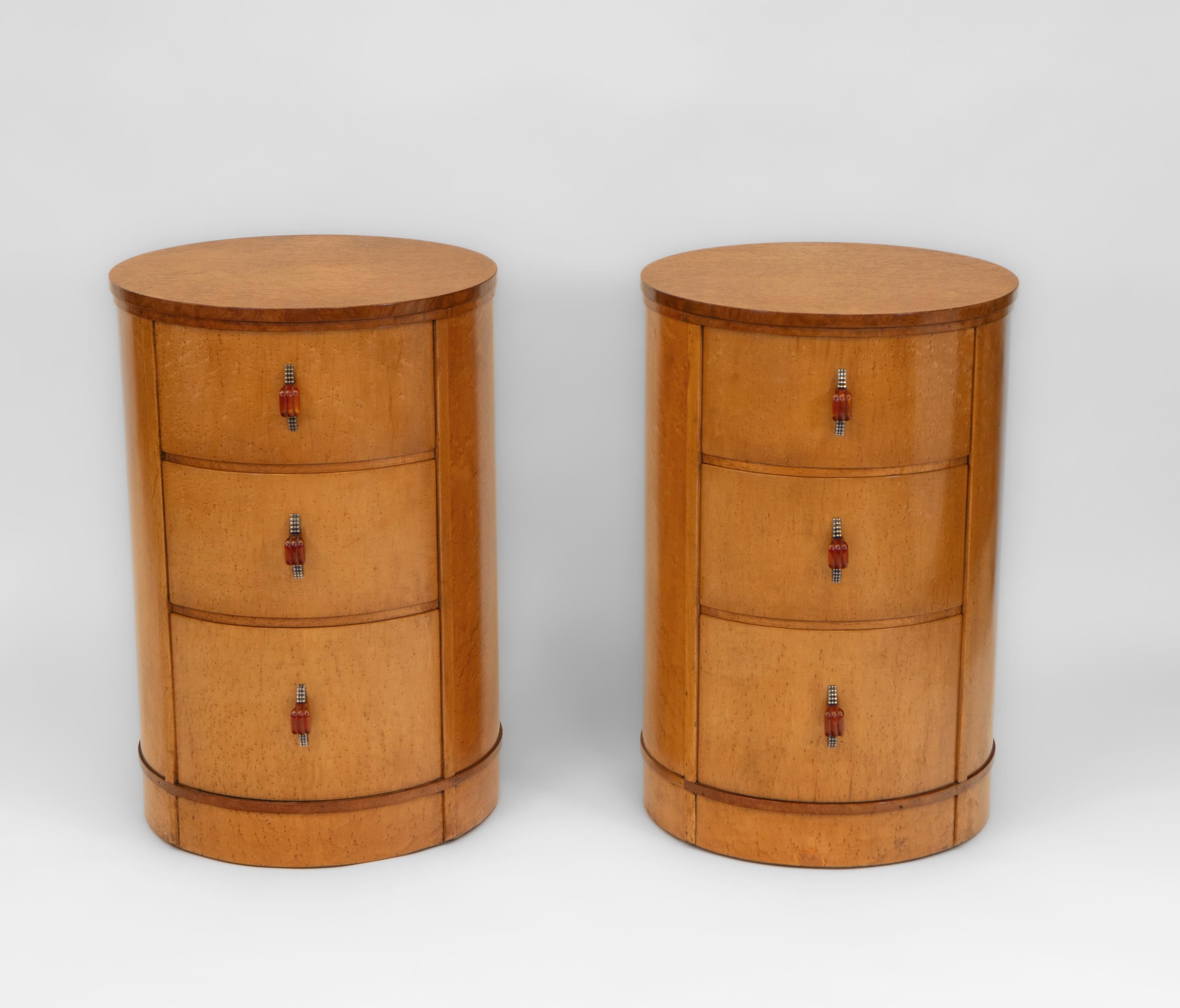 A superb pair of Art Deco bird's eye maple cylindrical bedside chests with chrome and Bakelite handles. English - Circa 1930.

Veneered in highly figured bird's eye maple, the chests have the fabulous original chrome and amber coloured Bakelite