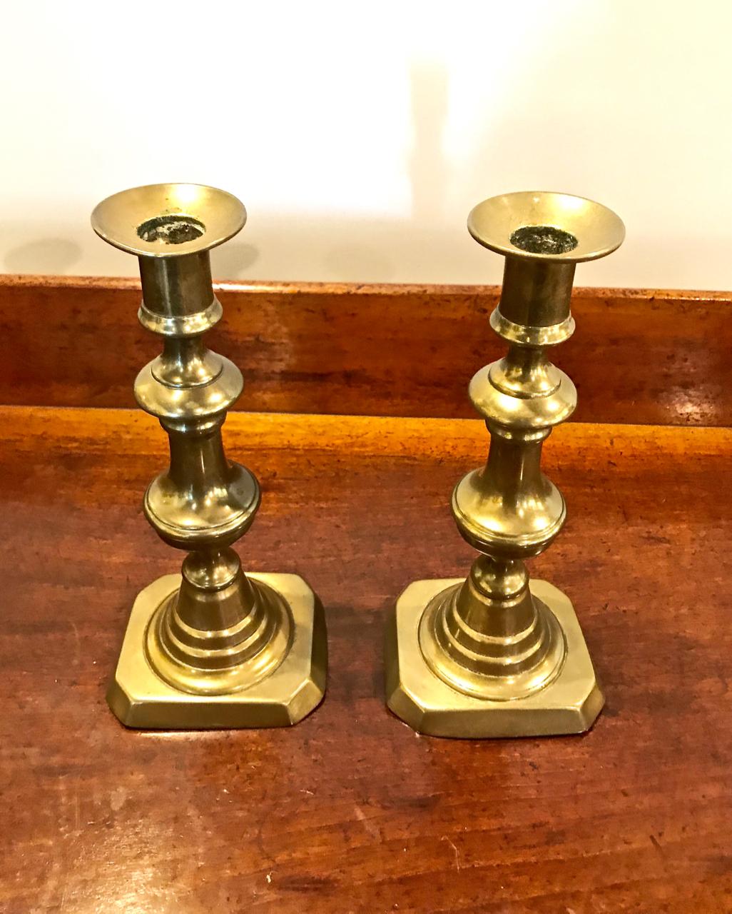 This is a great pair of mid-19th century English Victorian candlesticks. The sticks retain their original warm patina and iron push-ups. These candlesticks are very decorative displayed alone or bunched with similar sticks for greater impact.
