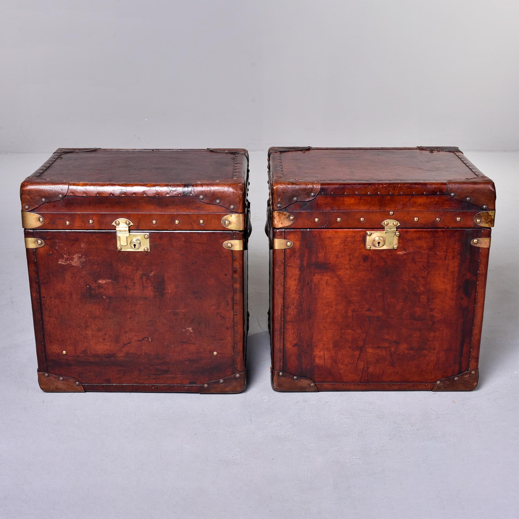 Pair of circa 1910 English leather covered trunks have been restored with new blue velour liners on the inside and reconditioned leather on the outside. Make great end tables. Sold and priced as a pair.