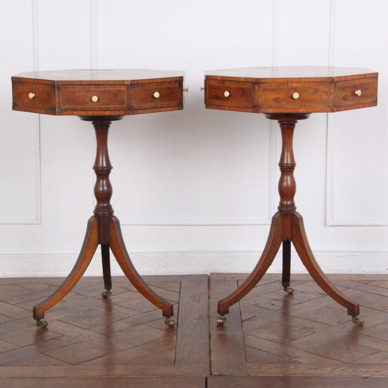 A pair of English octagonal inlaid yew wood side tables with rotating tops, each with two drawers, and raised on a pedestal base with out-swept sabre legs, with brass castors. Beautiful pieces with a small footprint making them ideal for virtually