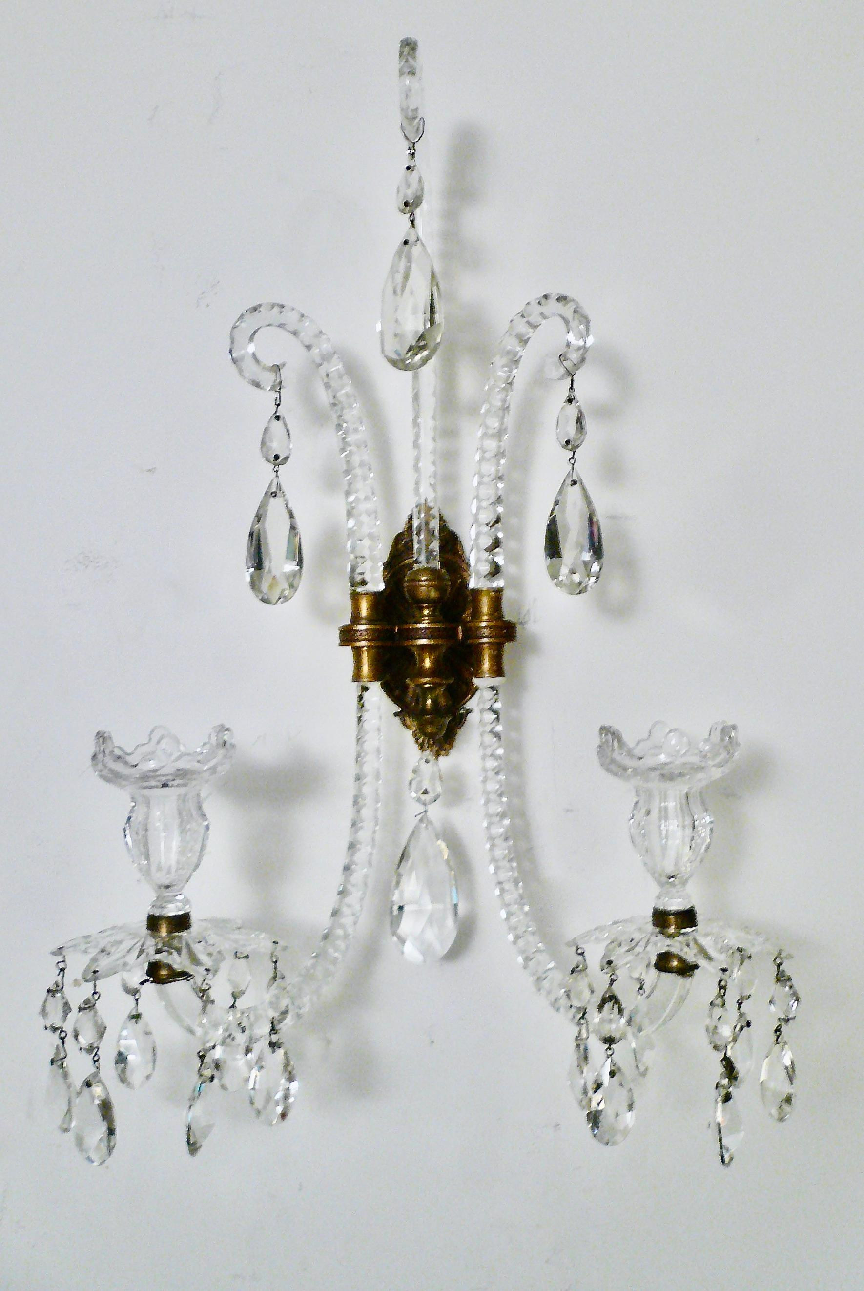  In the 1790s Moses Lafount invented a new design for chandeliers, candelabra, and wall brackets (sconces).  The essence of the design was that the arms should appear to pass vertically through the arm-plate in one continuous curve of glass. The