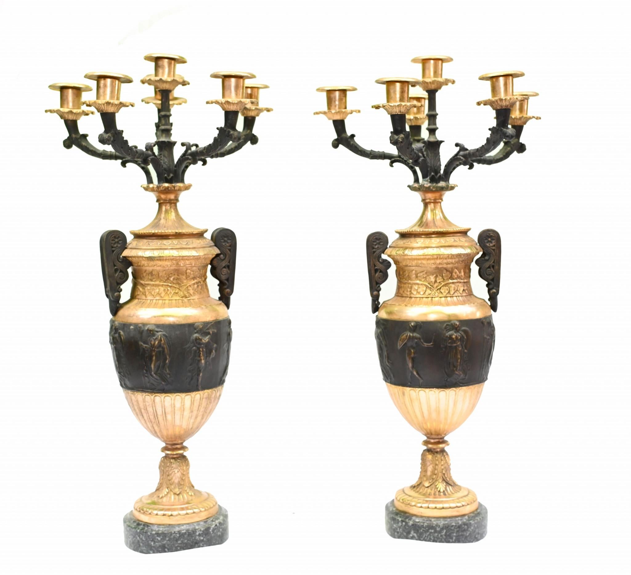 You are viewing a pair of antique gilt and bronze urns in the manner of Thomas Hope
The look is high Regency with a dazzling colour interplay between the black and gilt
They are classic amphora urns - Greek Revival - with various figures in