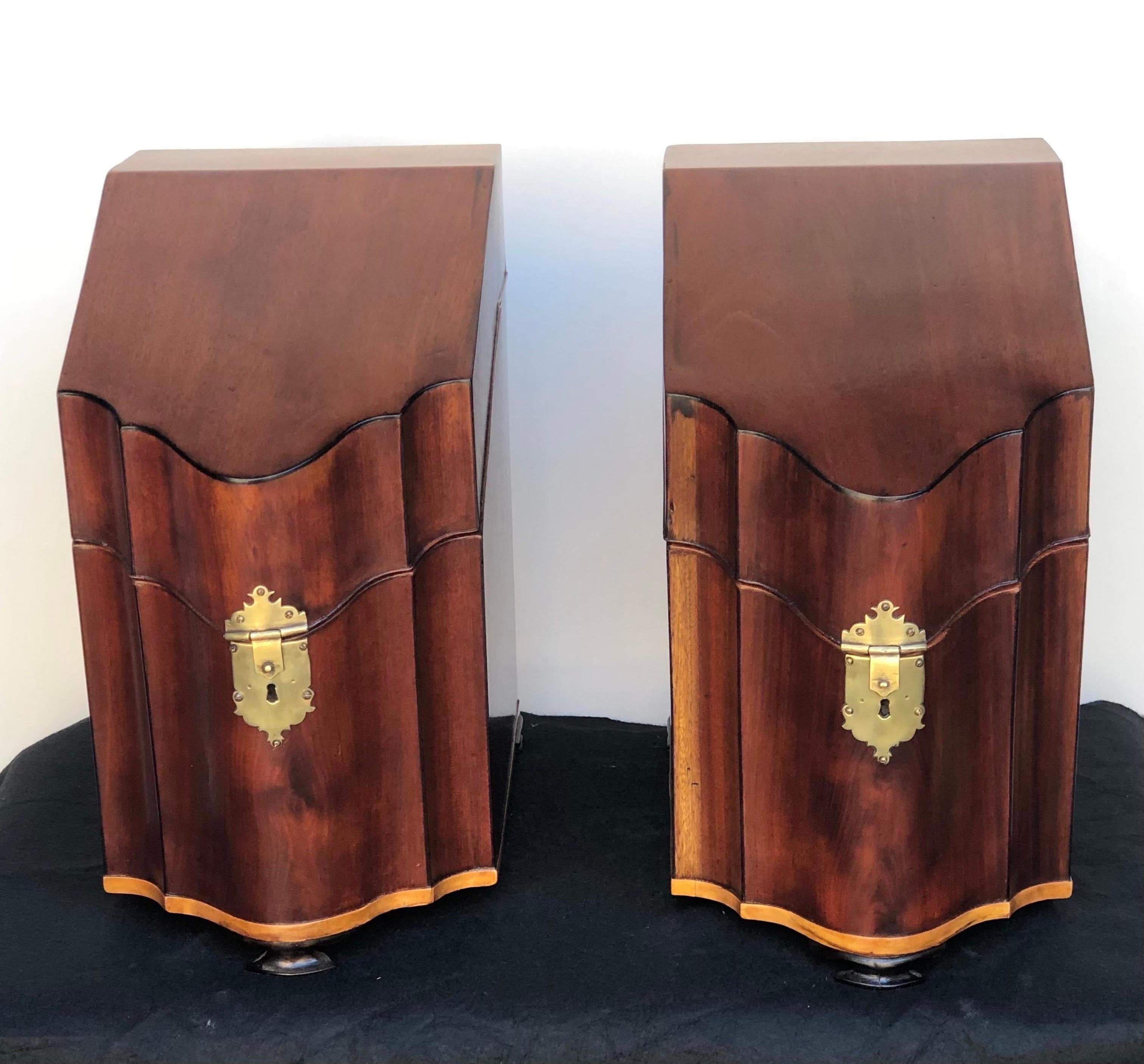 This Elegant pair of English George III mahogany Serpentine inlaid cutlery Boxes on Ogee Bracket Feet with the original Cutlery fitted interiors where made in the late 18th century. The neoclassical Serpentine knife boxes have a canted lid and are