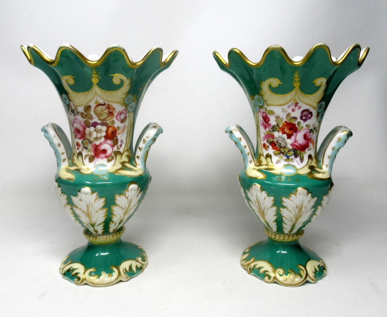 An exceptionally fine quality identical pair of English Rococo Revival twin handle mantle vases by Samuel Alcock, circa second quarter of the 19th century. 

Each vase of baluster outline with unusual flaired rims and wavy gilded edges, twin