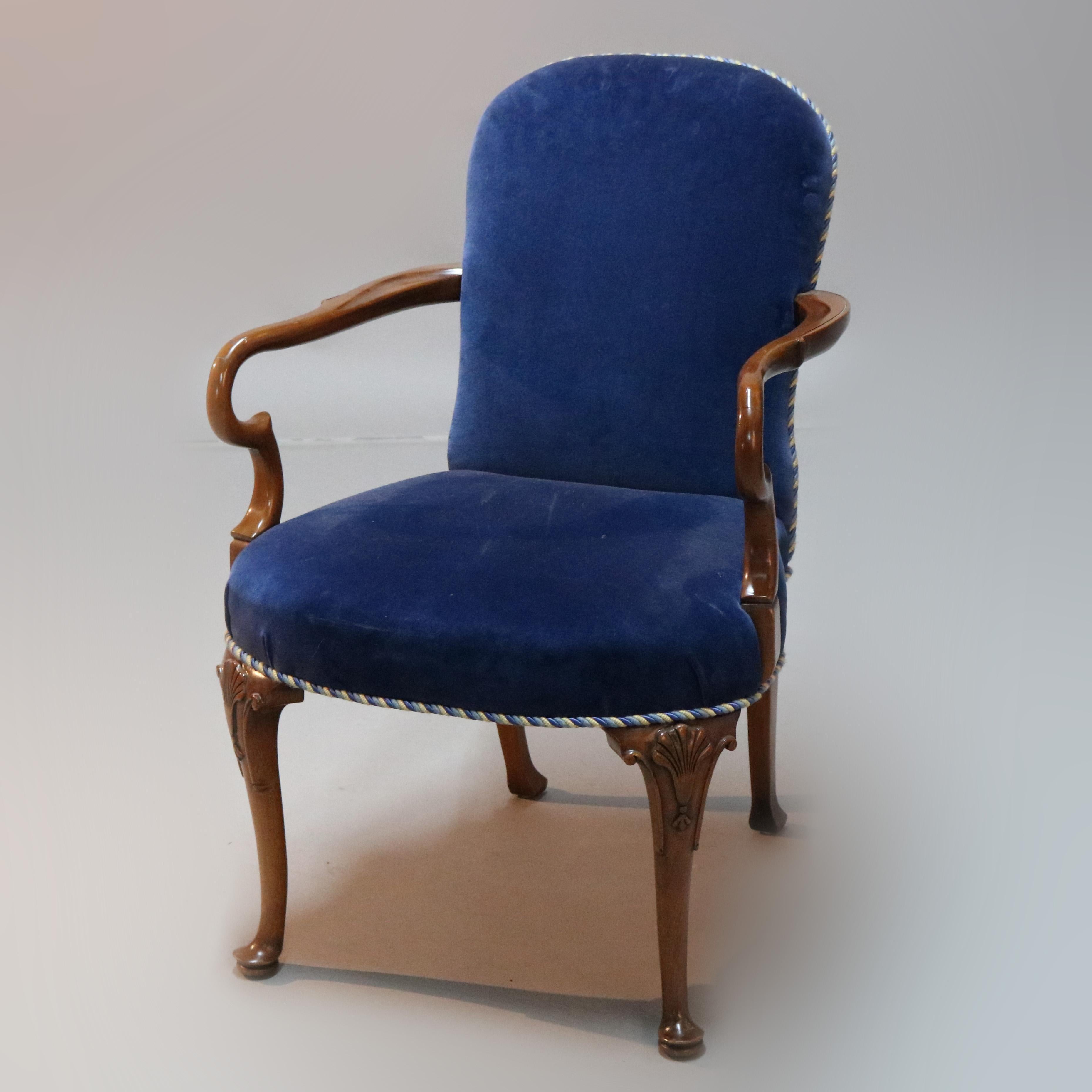 A vintage pair of English Queen Anne style armchairs offer sapphire blue velvet upholstered backs and seats with carve mahogany fraes having cabriole legs with stylized shell carved knees and terminating in pad feet, circa 1940

Measures: 36