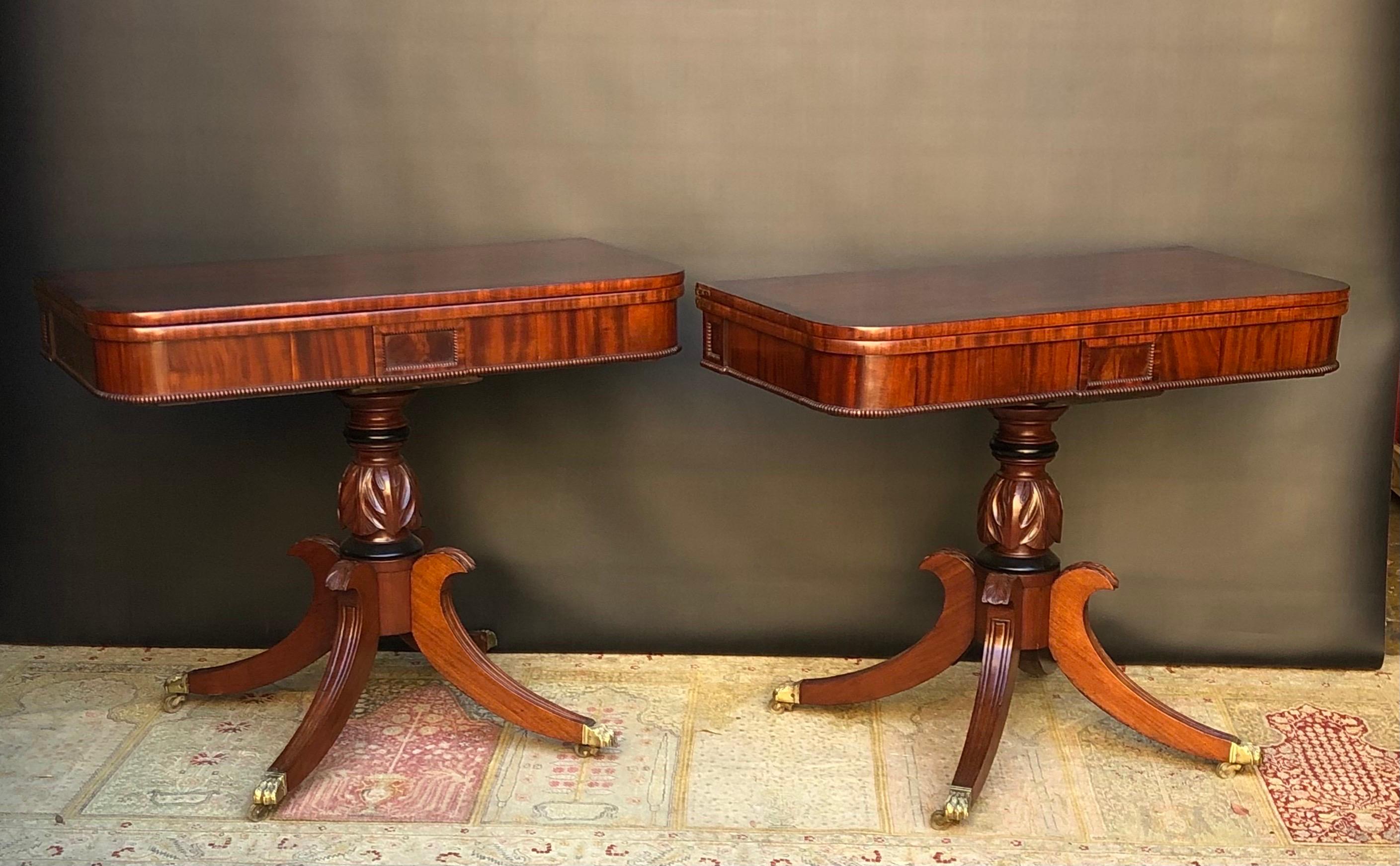 This Regal pair of English Regency Mahogany Card Tables  / Tea Tables with Rosewood Crossbanding are made in the first quarter of the  19th Century.  The English NeoClassical Tea Table top has a highly figured Crotch Mahogany surrounded by elegantly