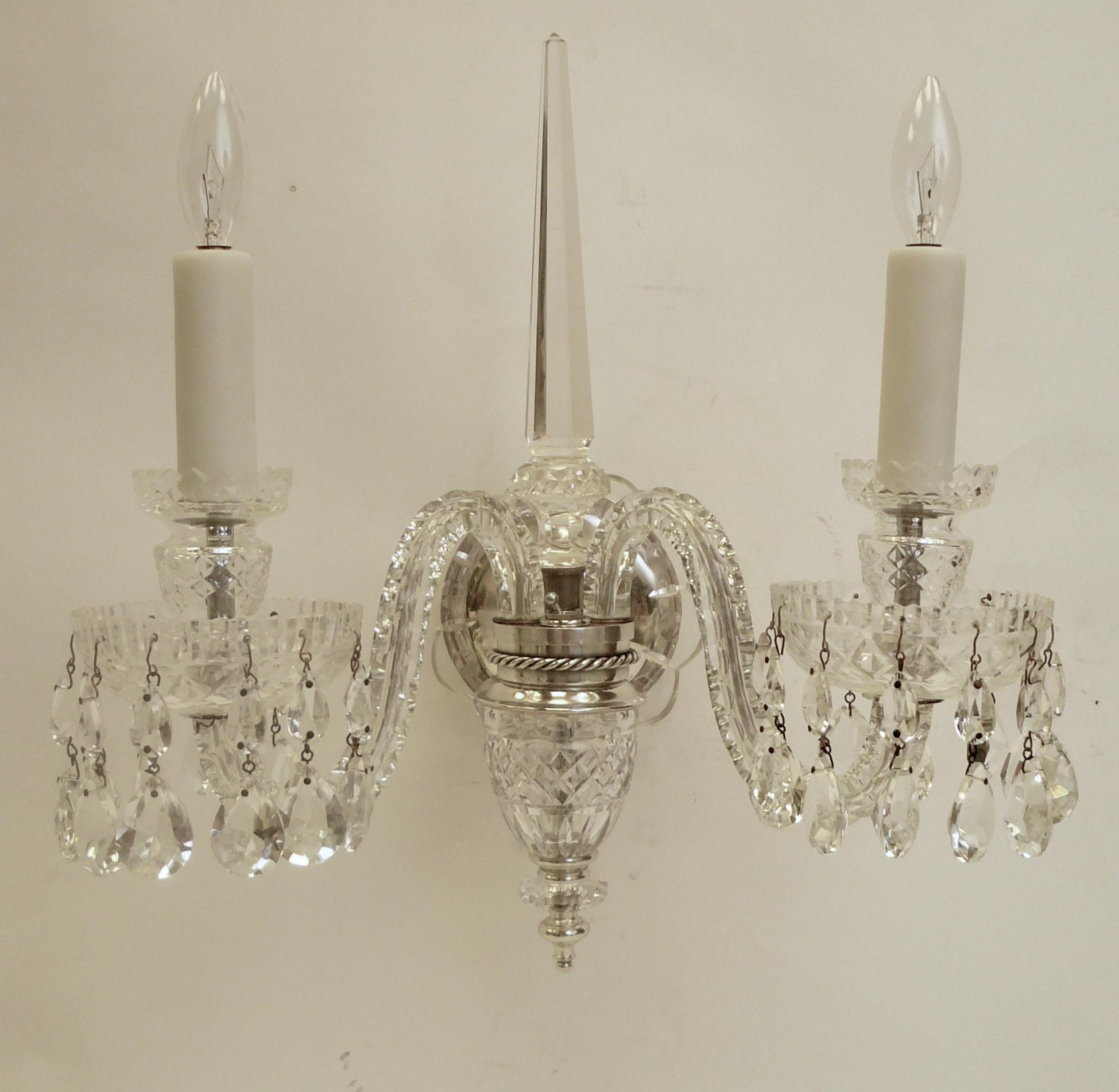 This pair of quality sconces feature pear cut drops, crystal obelisks, and silvered rope motif fittings.