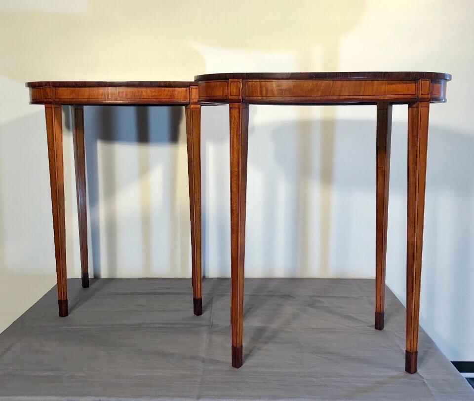 Elegant English satinwood tea tables with opposing Classic oriental tea ceremony design inlaid in the satinwood tops with rosewood crossband. These English tables have satinwood legs with string inlay and cuff feet. The tops are wonderfully inlaid.