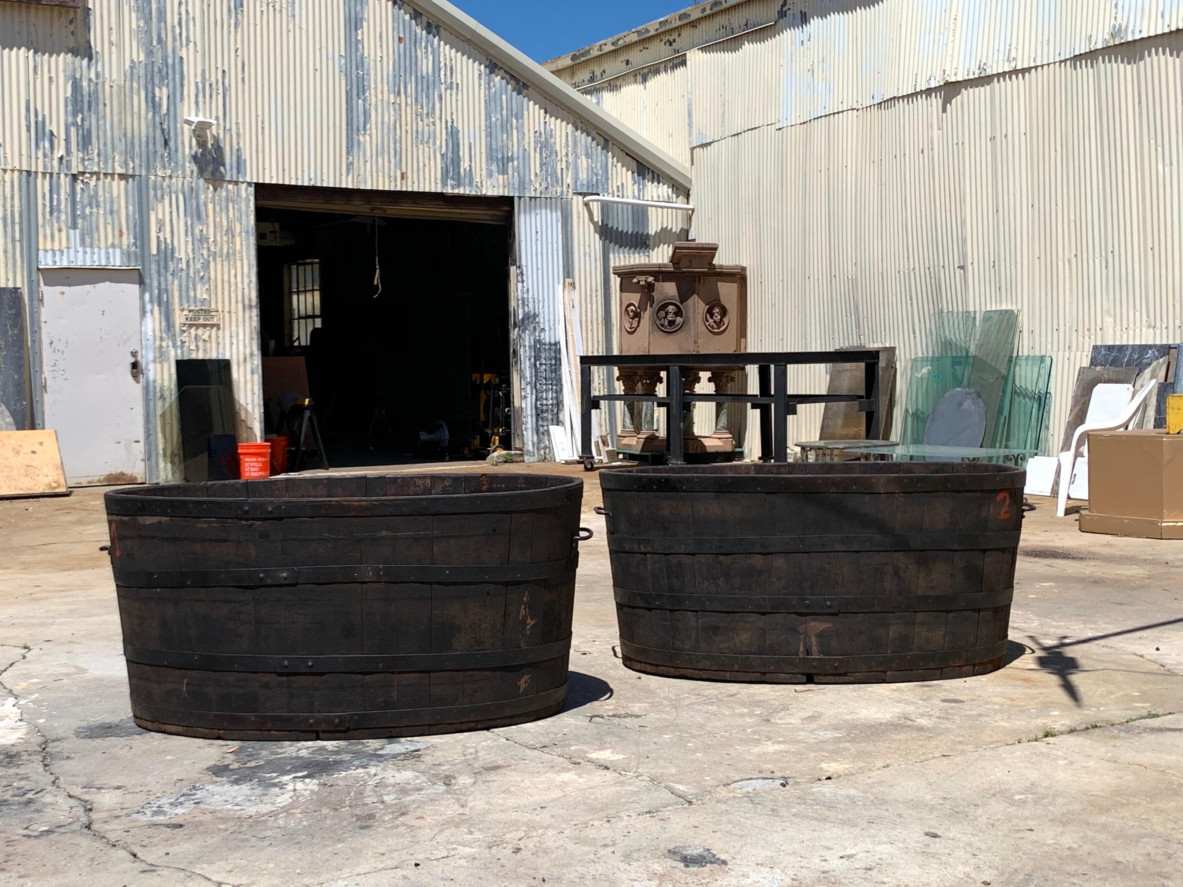 With vertical blanks and solid floors, these large buckets are reinforced with metal bands and have large iron handles; marked M.T. which we assume is a metric ton or roughly 2200 lbs. Measures: Interior height 27