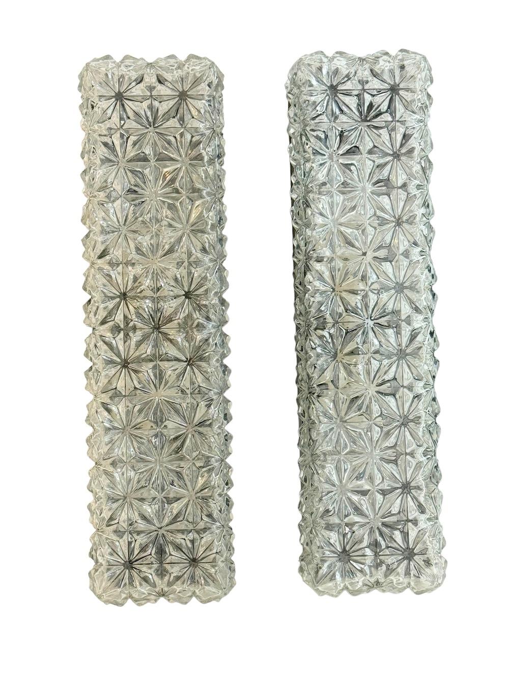 A gorgeous pair of flush mount or wall lights by Erco Leuchten Germany. Heavy ice glass on a bakelite fixture. The light fixture requires two European E14 / 110 Volt Candelabra bulbs, each bulb up to 60 watts. A nice addition to any room or hallway.