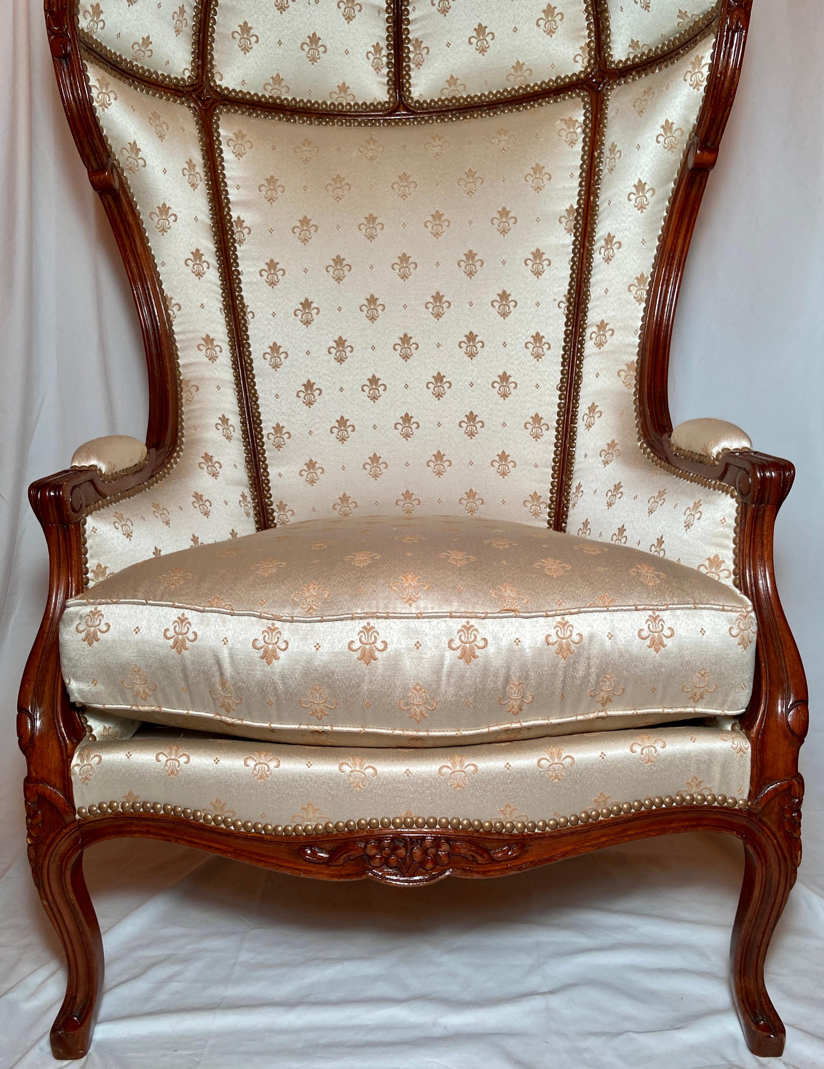 Pair Estate French walnut ivory & gold Fleur-de-Lis upholstered balloon canopy porters chairs with grommet details. Circa 1940's.
These chairs are in excellent condition, very comfortable and nicely upholstered.
