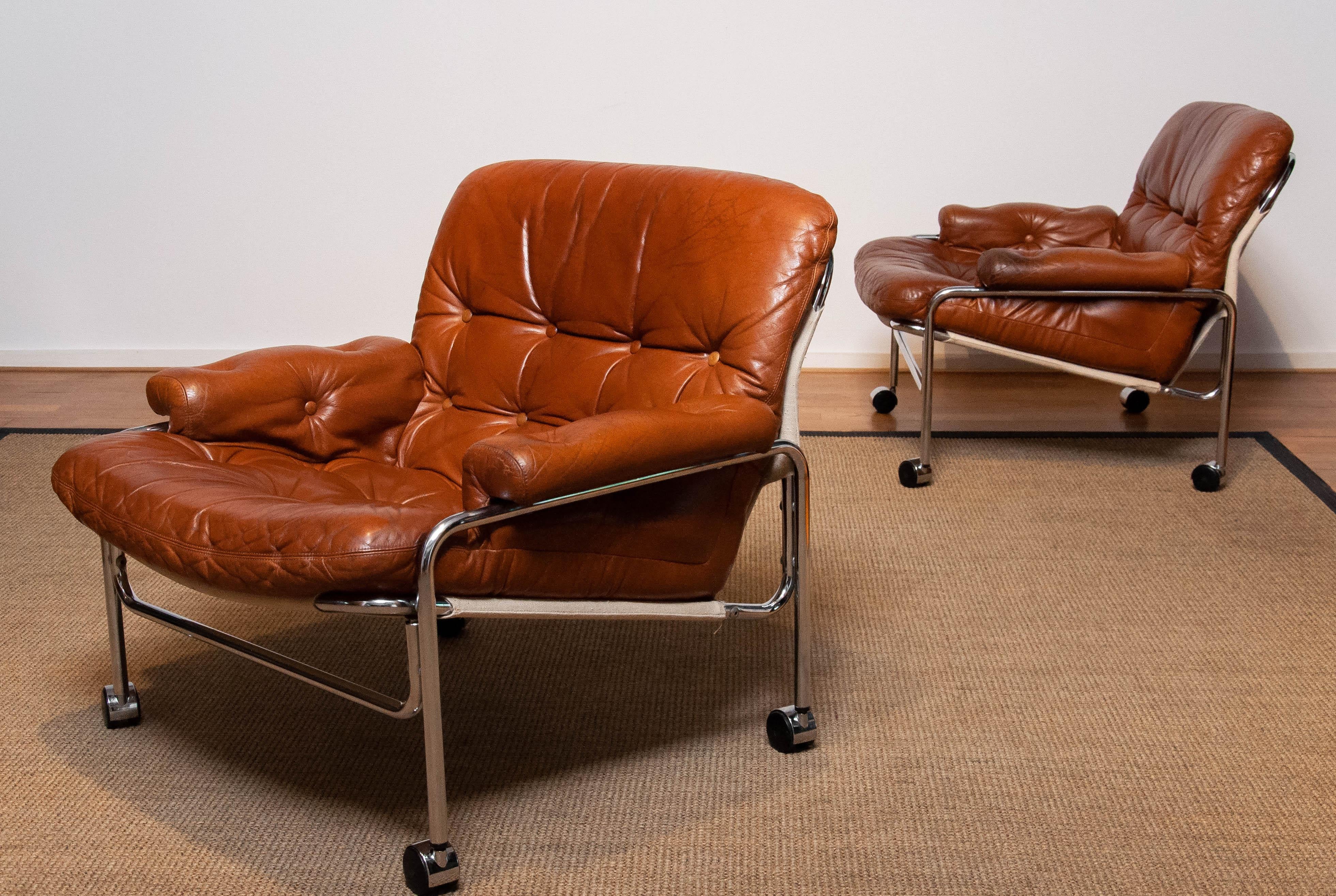 Mid-20th Century Pair 'Eva' Lounge Chairs Chrome and Aged Brown / Tan Leather by Lindlöfs Möbler