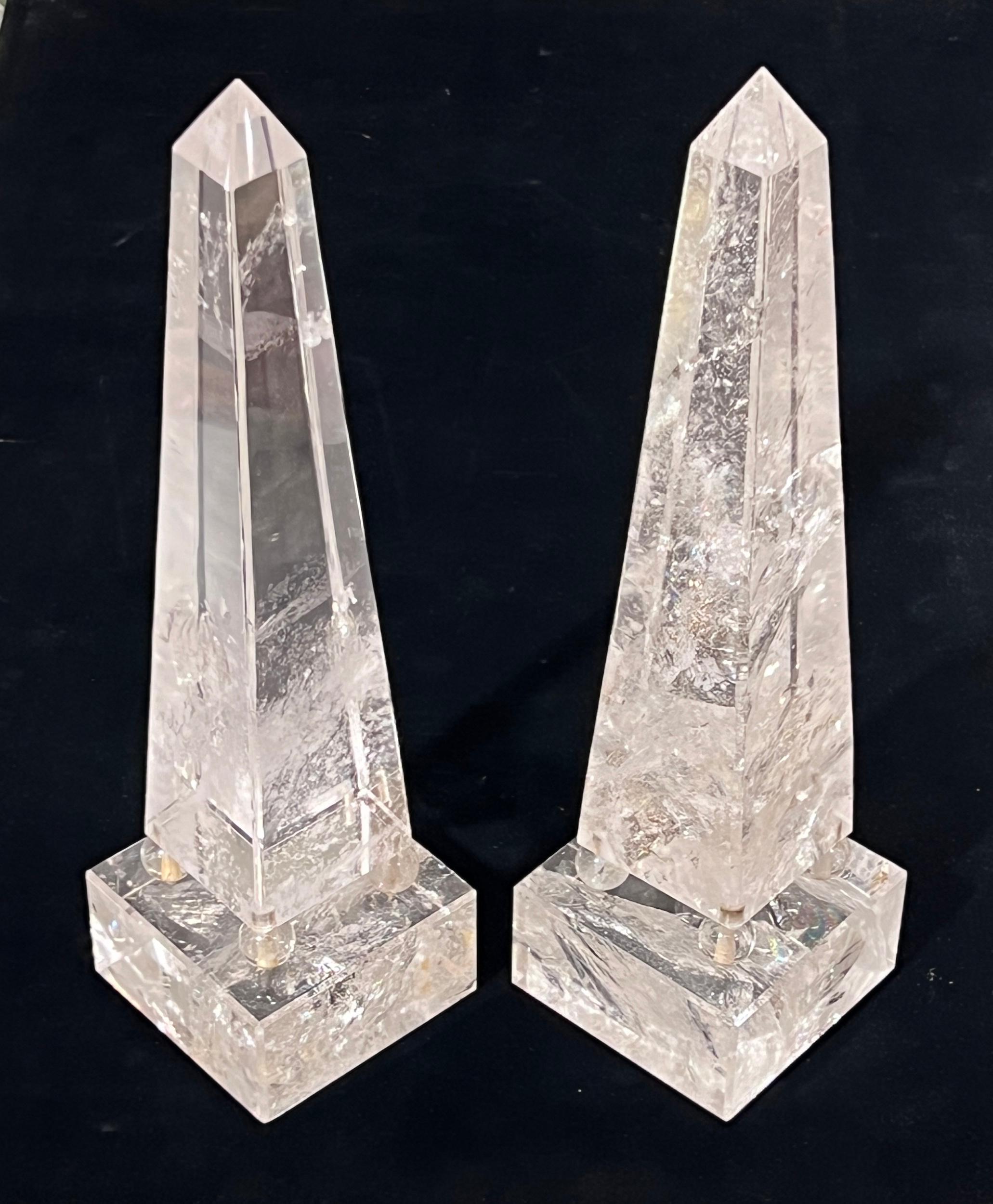 Pair of matching antique Art Deco  rock crystal obelisks of the finest quality, crystal clear with clear occlusions, and unique for their square pedestals and mounts with spherical rock crystal feet.