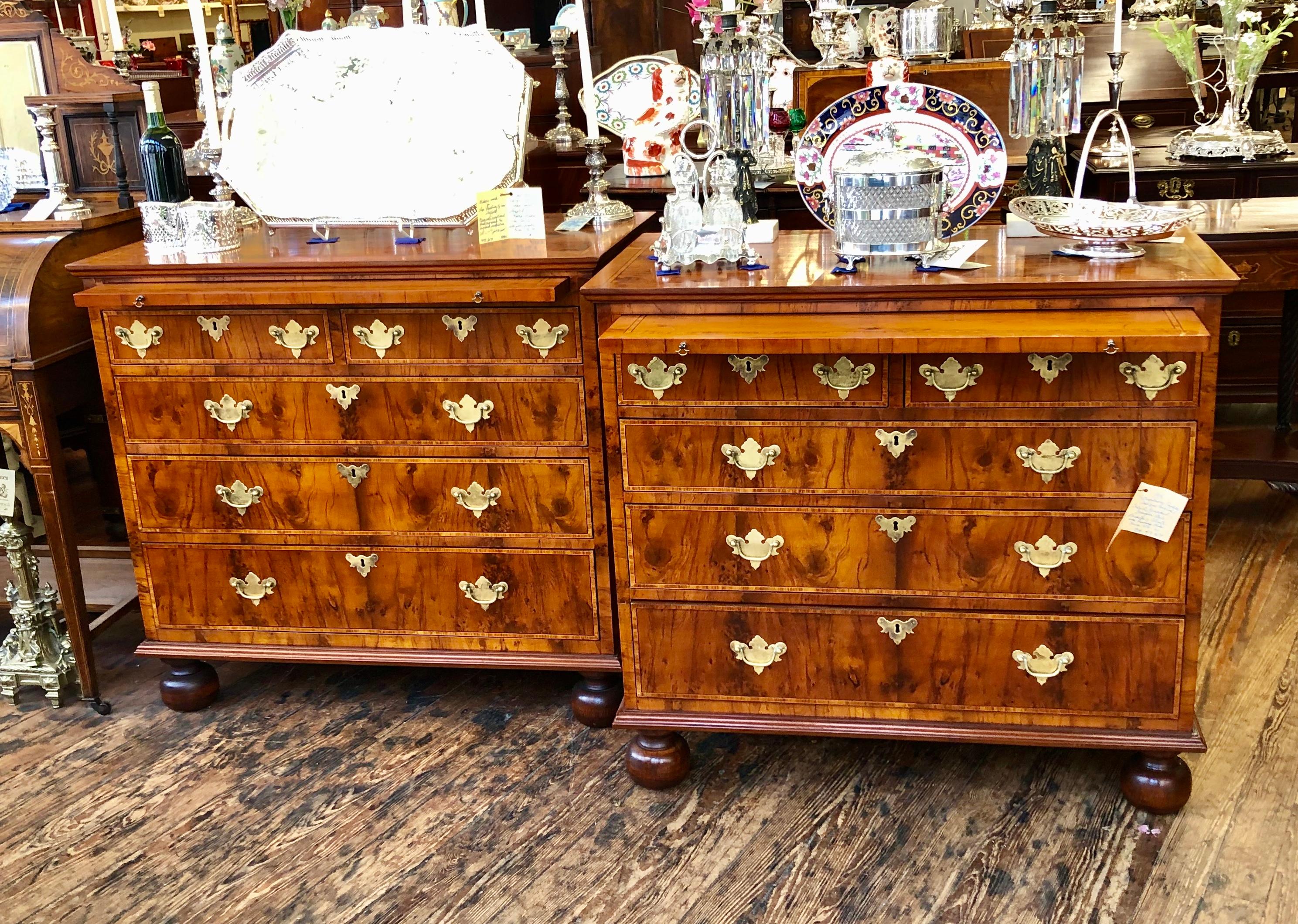 Pair of exceptionally rare and fine antique English inlaid yew wood Queen Anne Revival bachelor's chests with tulipwood inlay, bunn feet and inlaid brushing slides. The condition of the pair is pristine. This pair is very useful in many areas of the