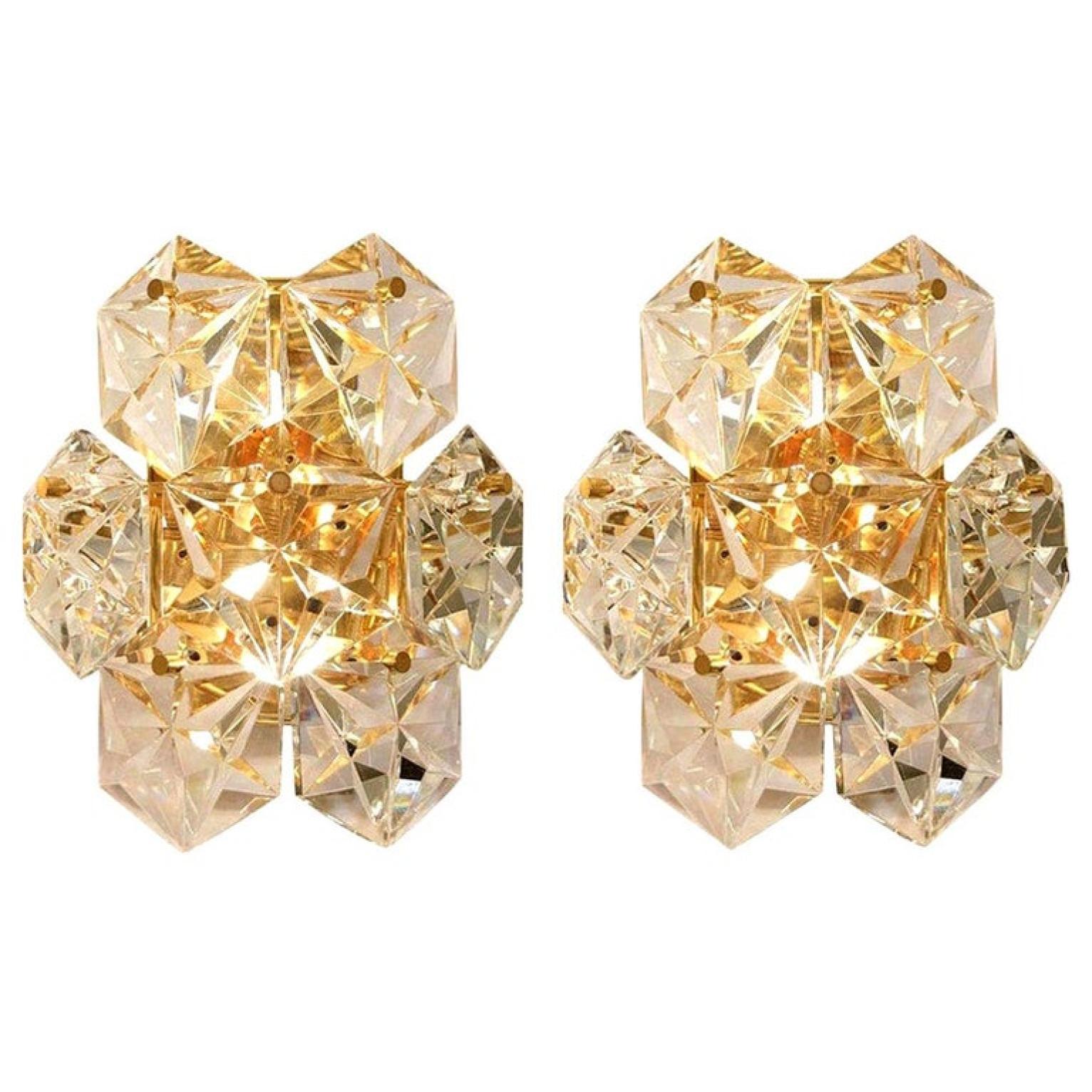 One of the three pairs luxurious gold-plated frames and thick diamond crystal sconces by the famed maker, Kinkeldey. Two-light sources. Very elegant light fixtures, comfortable with all decor periods. The crystals are meticulously cut in such a way