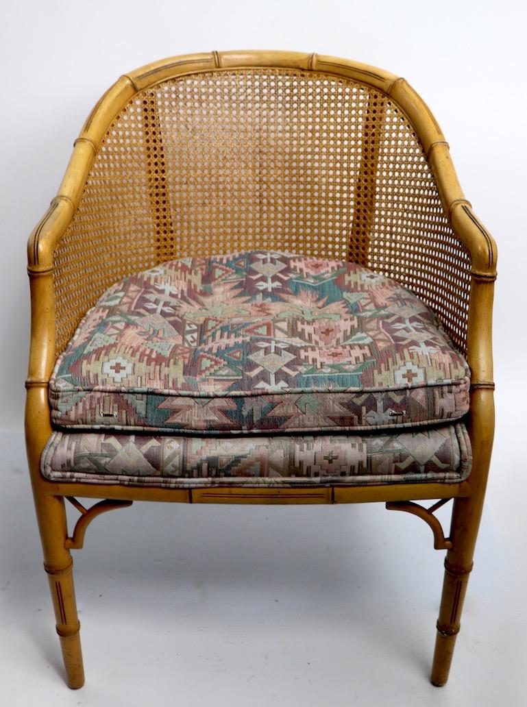 Stylish pair of faux bamboo cane back chairs made by the Century Chair Company. Both chairs are in good original condition, both show some cosmetic wear to finish and general wear to the fabric seats. Hollywood Regency classics, offered and priced