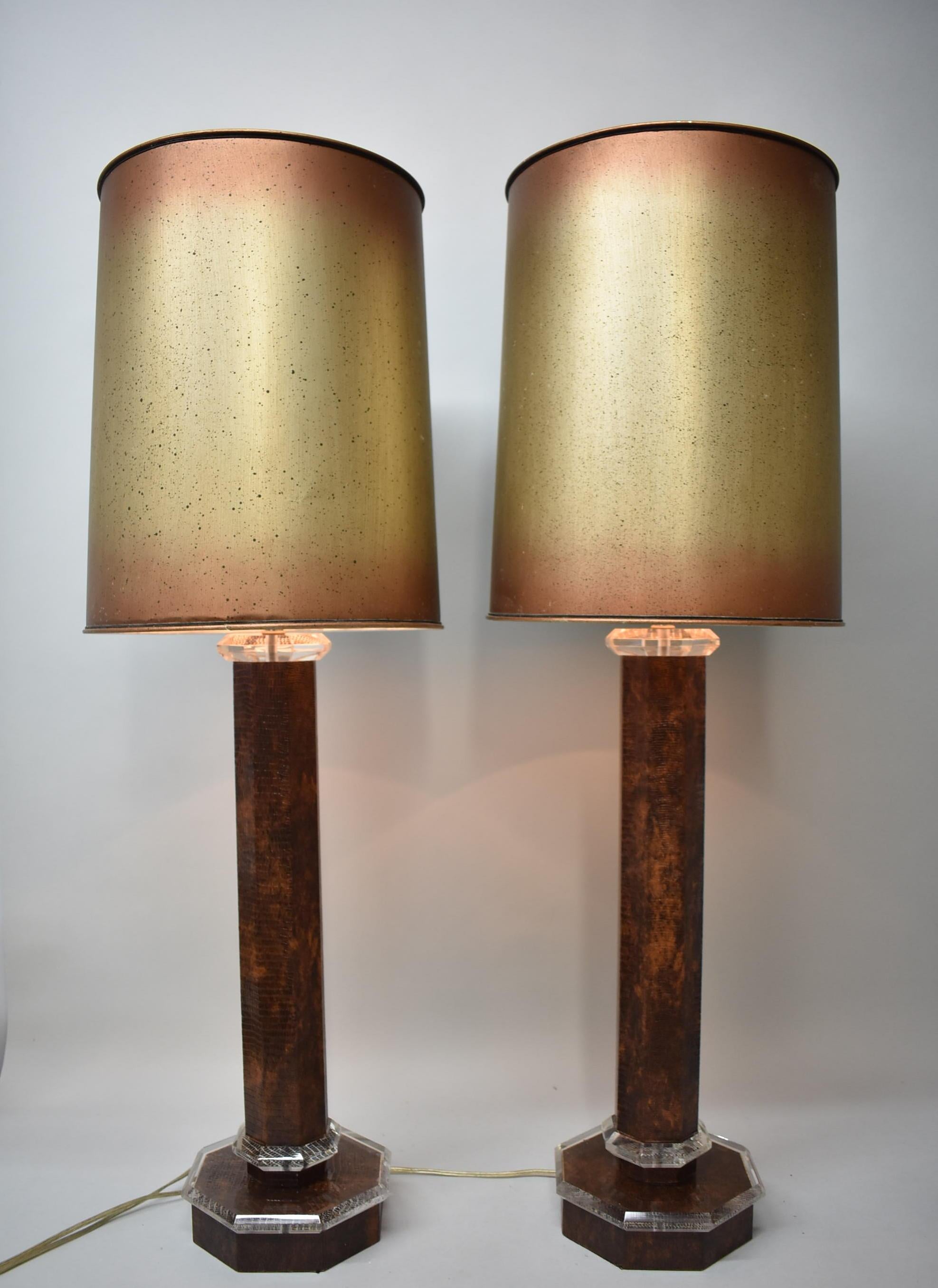Pair of faux leather / whip snake skin and Lucite table lamps attributed to Karl Springer. Heptagon column base.