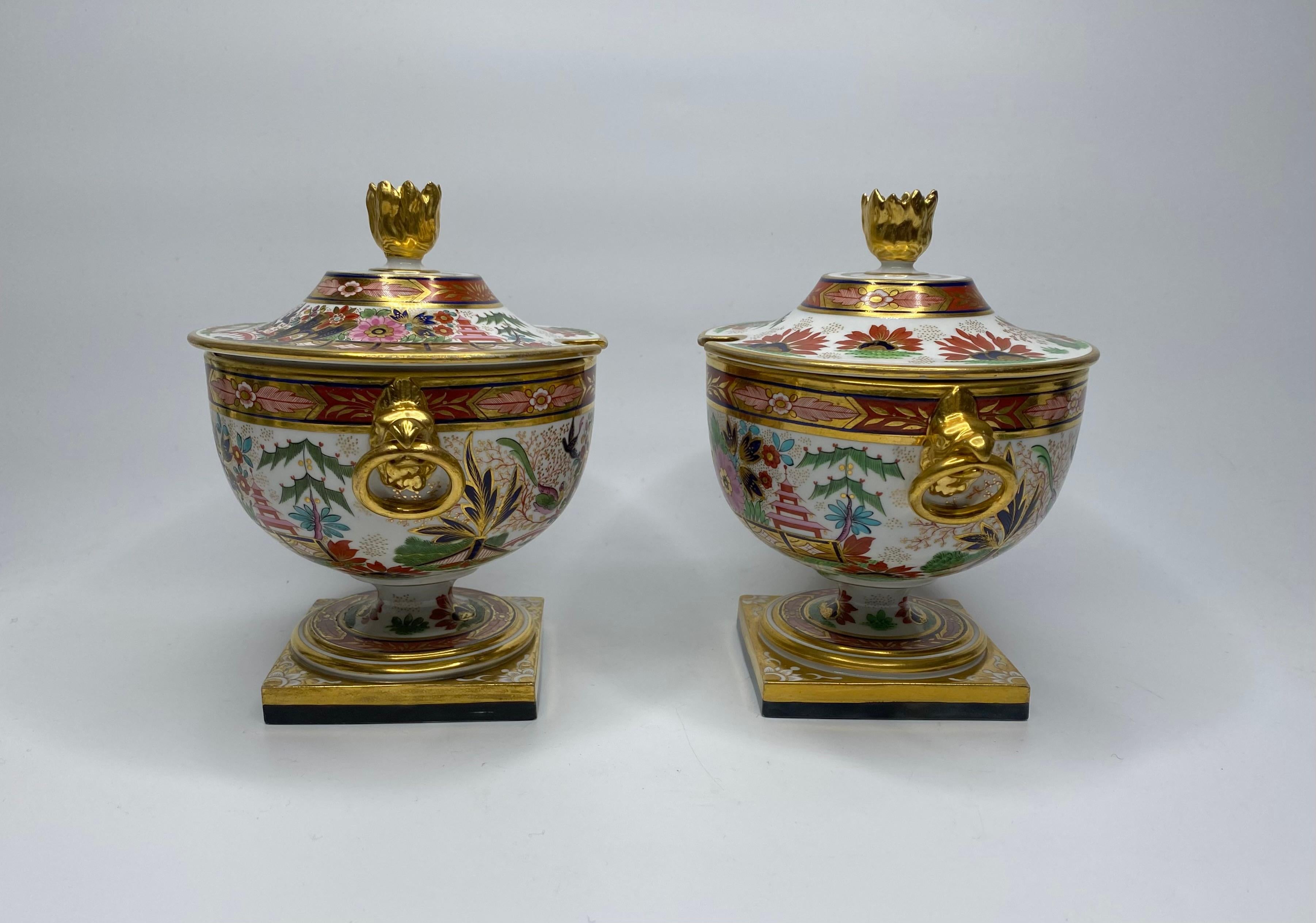 An exceptionally fine pair of Barr, Flight and Barr Worcester porcelain sauce tureens, and covers, c. 1810.
Both urn form tureens moulded with twin gilt eagle mask handles, holding circular rings, and set upon square pedestal bases. Hand painted in