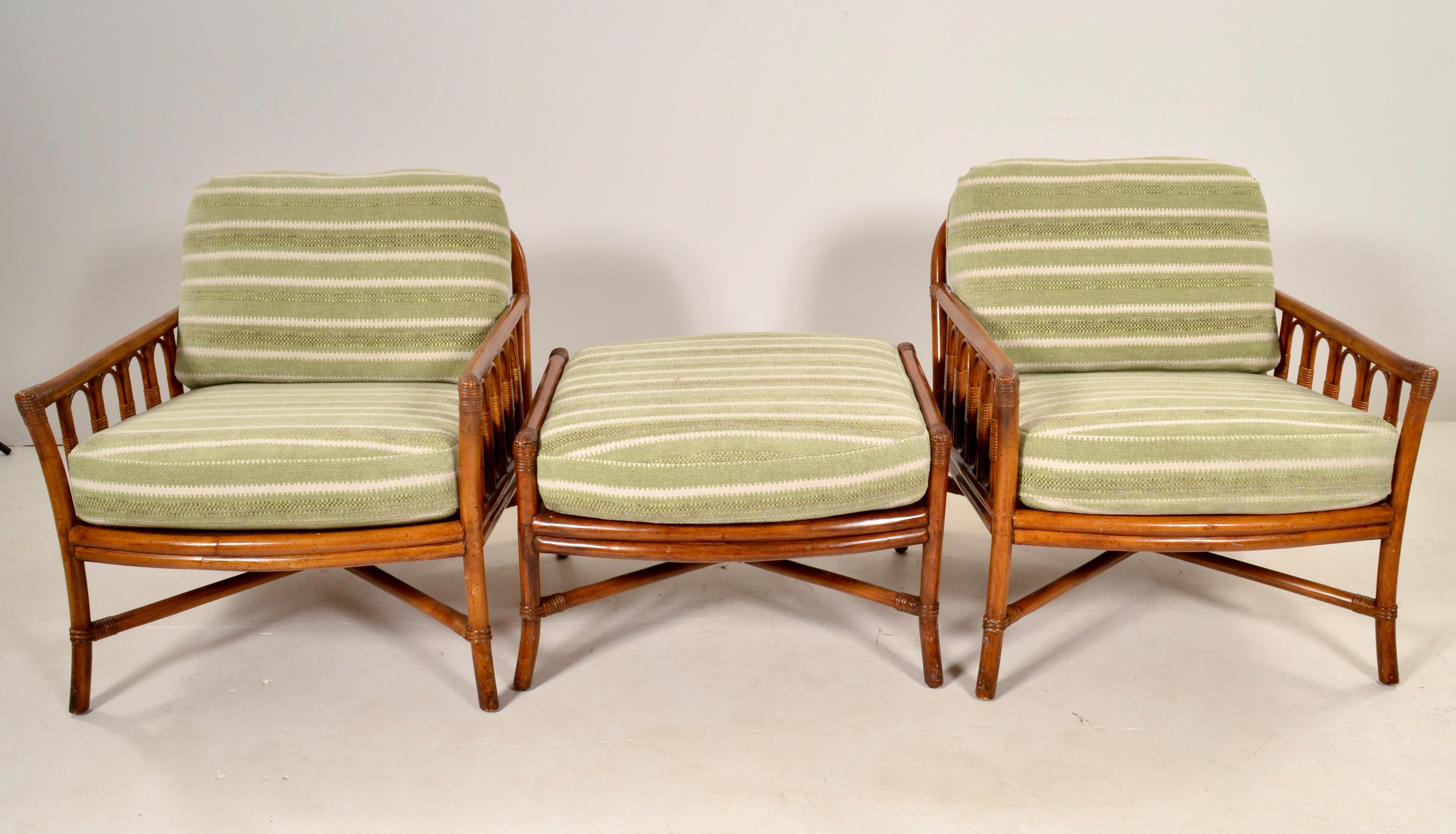 A handsome pair with single ottoman from Ficks Reed, well known for superior quality rattan furniture. The cushions and upholstery are all new. Chairs are in very, very fine condition. Super comfortable!  The chairs measure 29