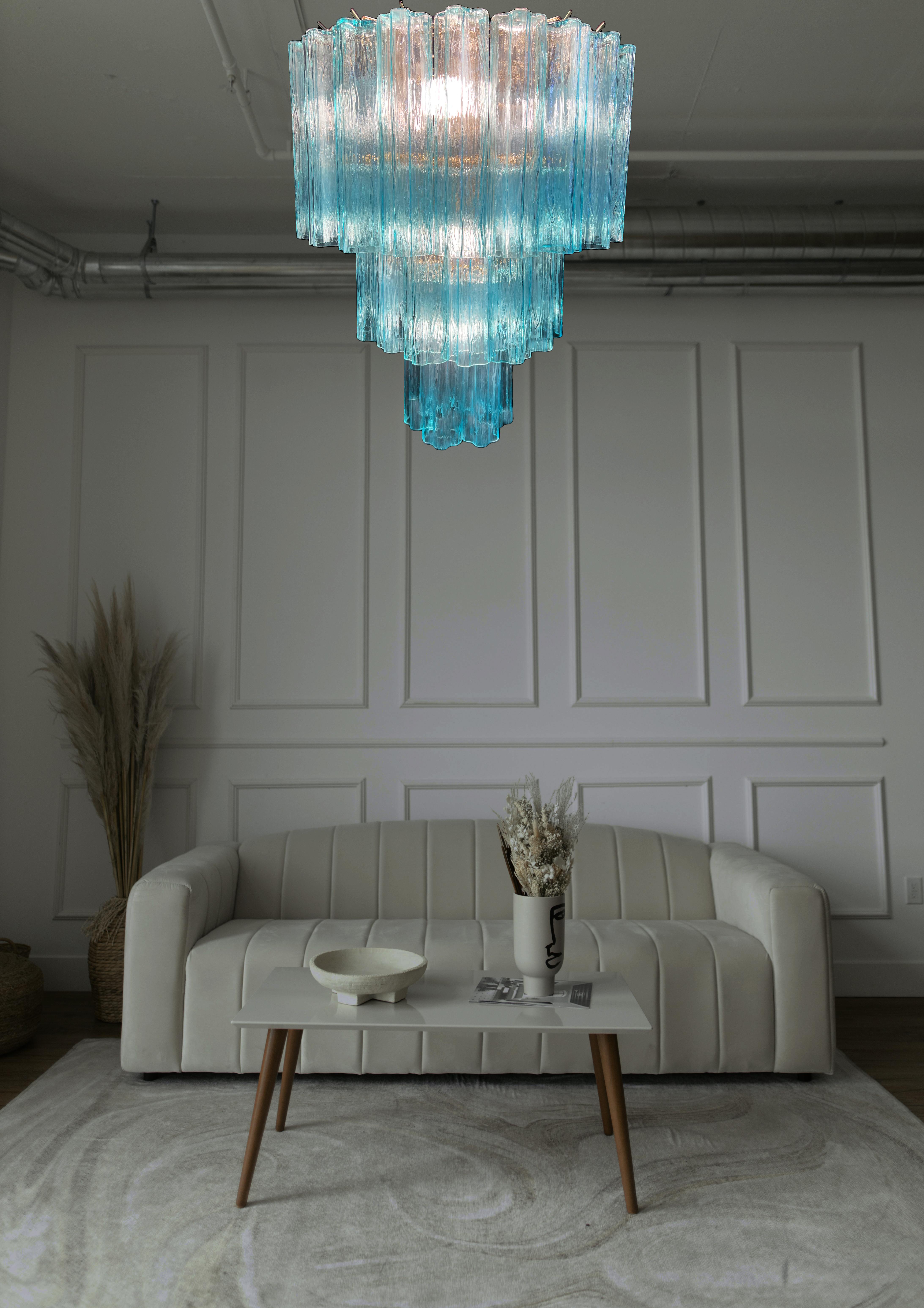 Chandelier of refined elegance. The blue hues reflect the light harmoniously. Made of pure Murano glass elements. A larger and a smaller version is also available. Also available for 220 volts outside the USA.