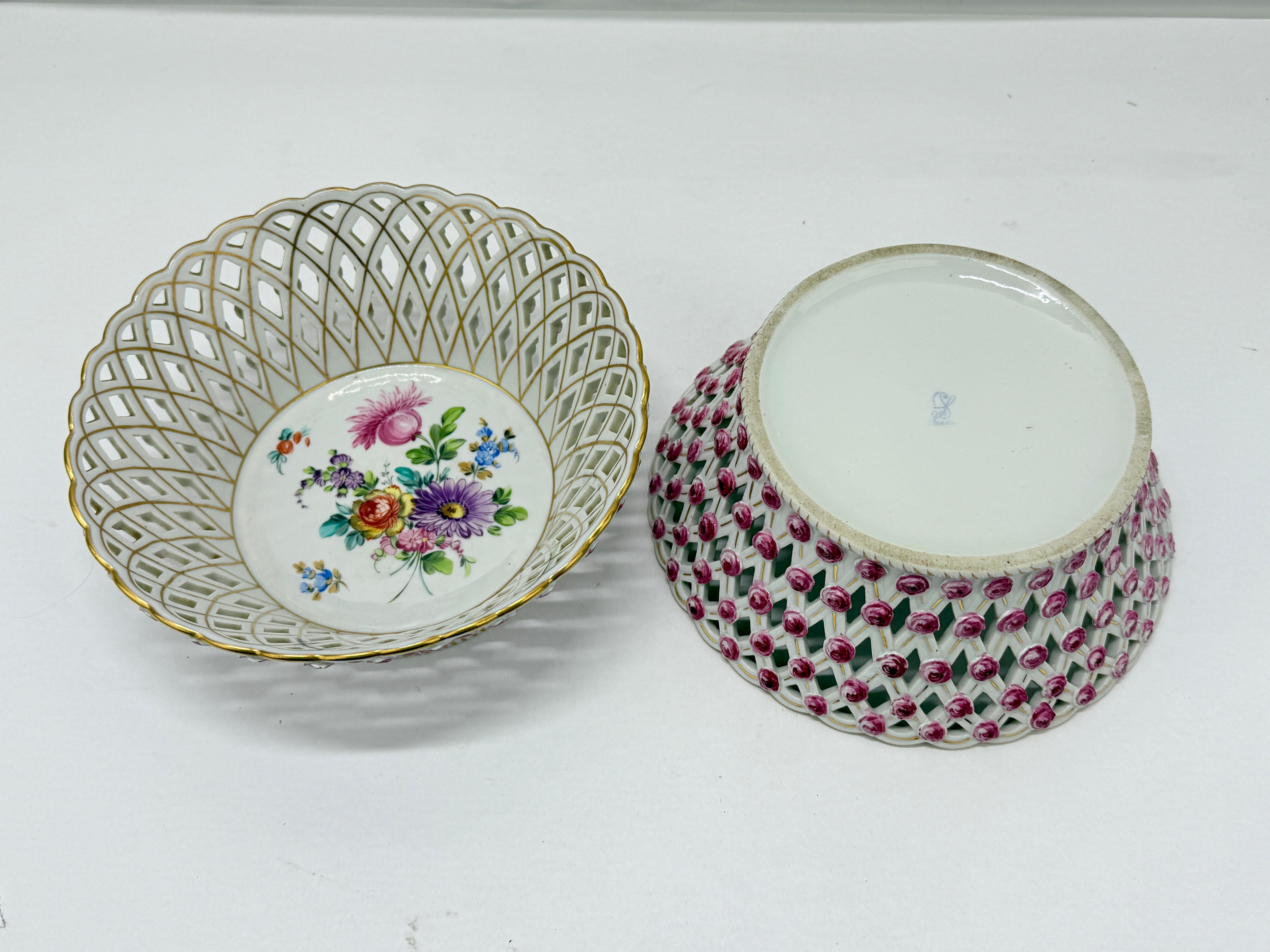 This exquisite pair of Dresden porcelain baskets, dating to circa 1910, showcases the exceptional artistry and attention to detail for which Dresden porcelain is celebrated.  

The interiors of the baskets are adorned with charming hand-painted
