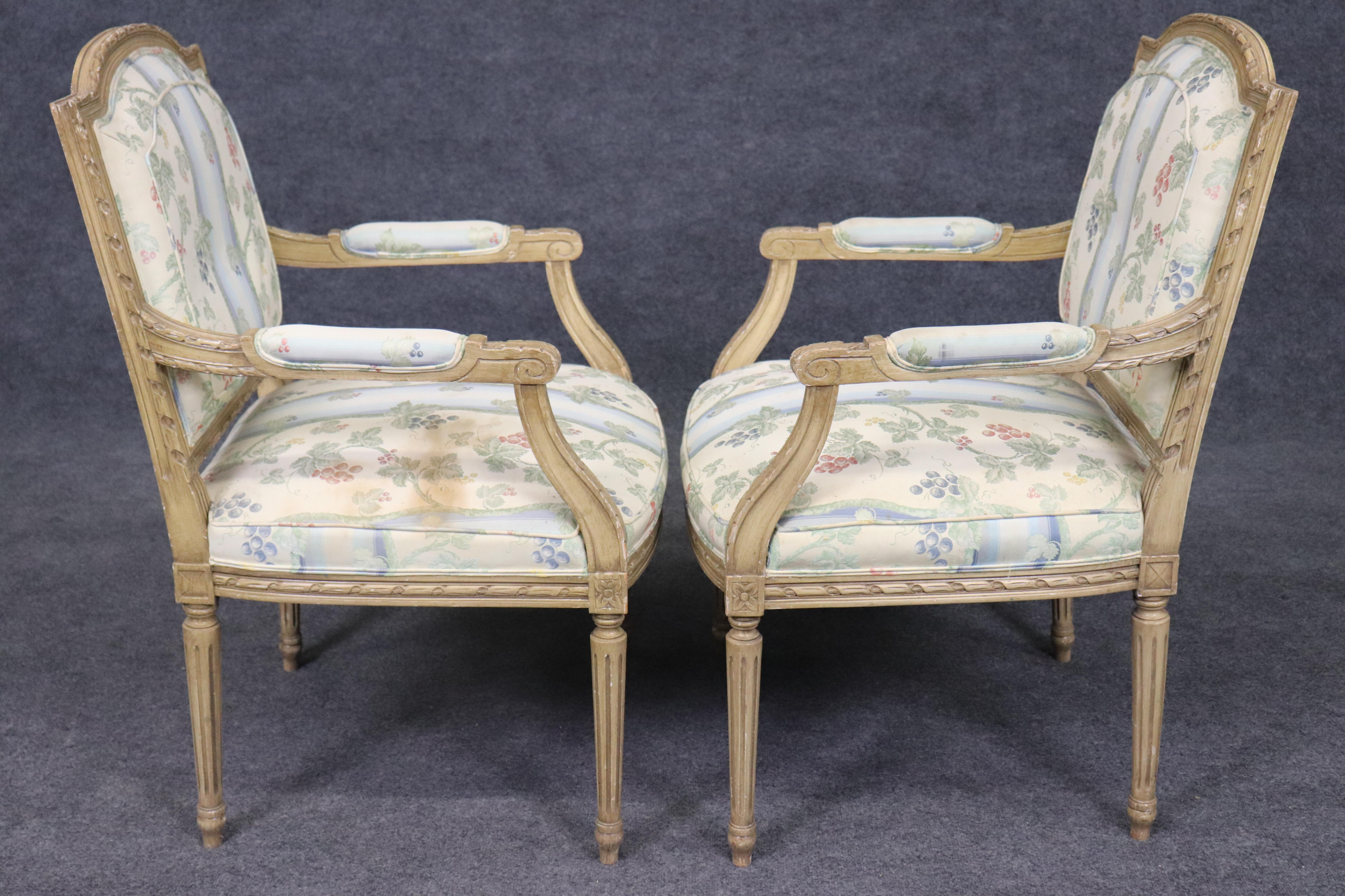 This is a fantastic pair of French-made Louis XVI style armchairs. The chairs are painted in a beautiful off-white hue with nice upholstery. The chairs are graceful, and have a light presence. The chairs are in good condition with minor signs of age