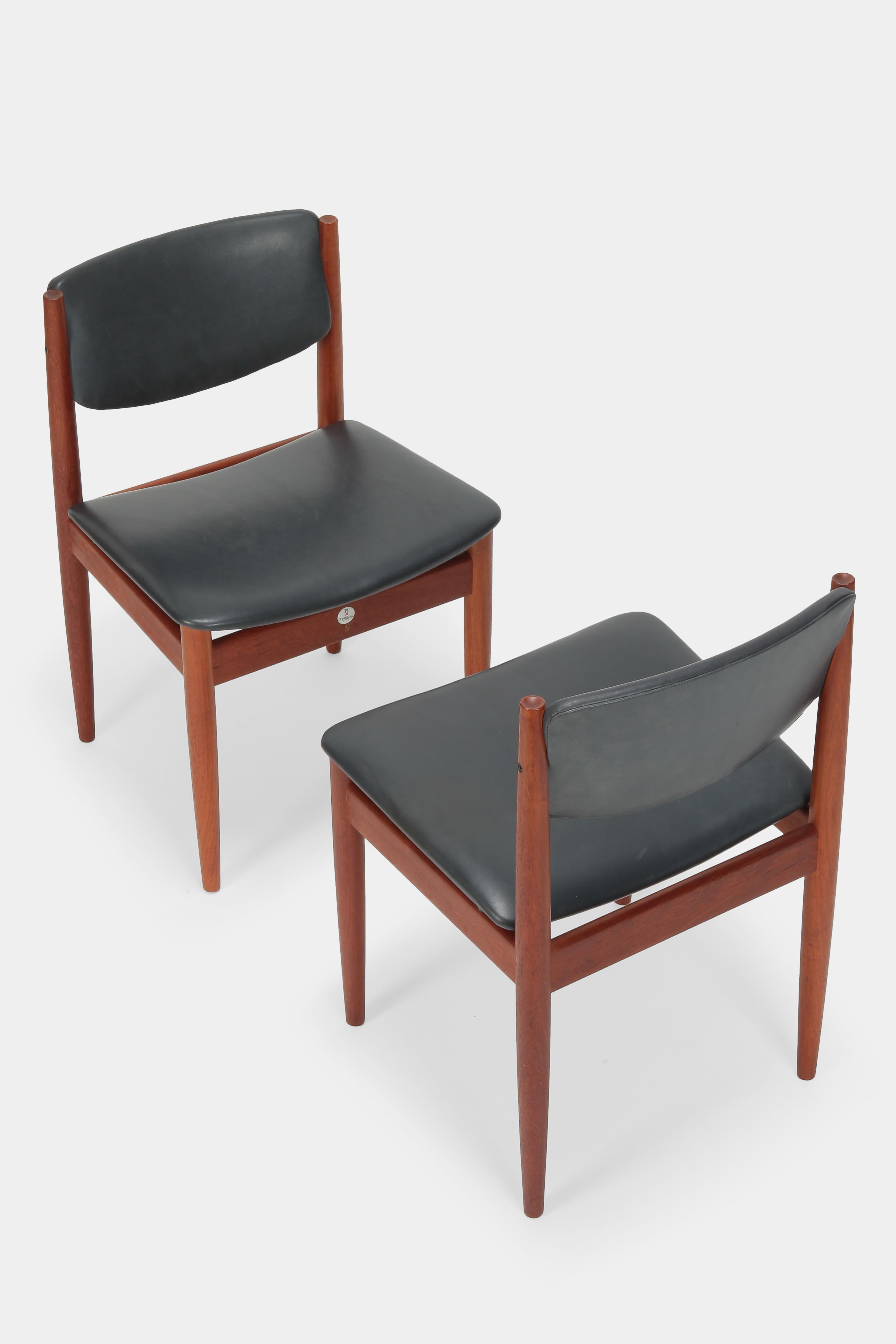 Two Finn Juhl model 197 chairs made by France and Son in Denmark in the sixties. Solid teak frame with very high production quality. Covered with Fine soft leather. Manufacturer aluminium label with production number under the seat. In very nice