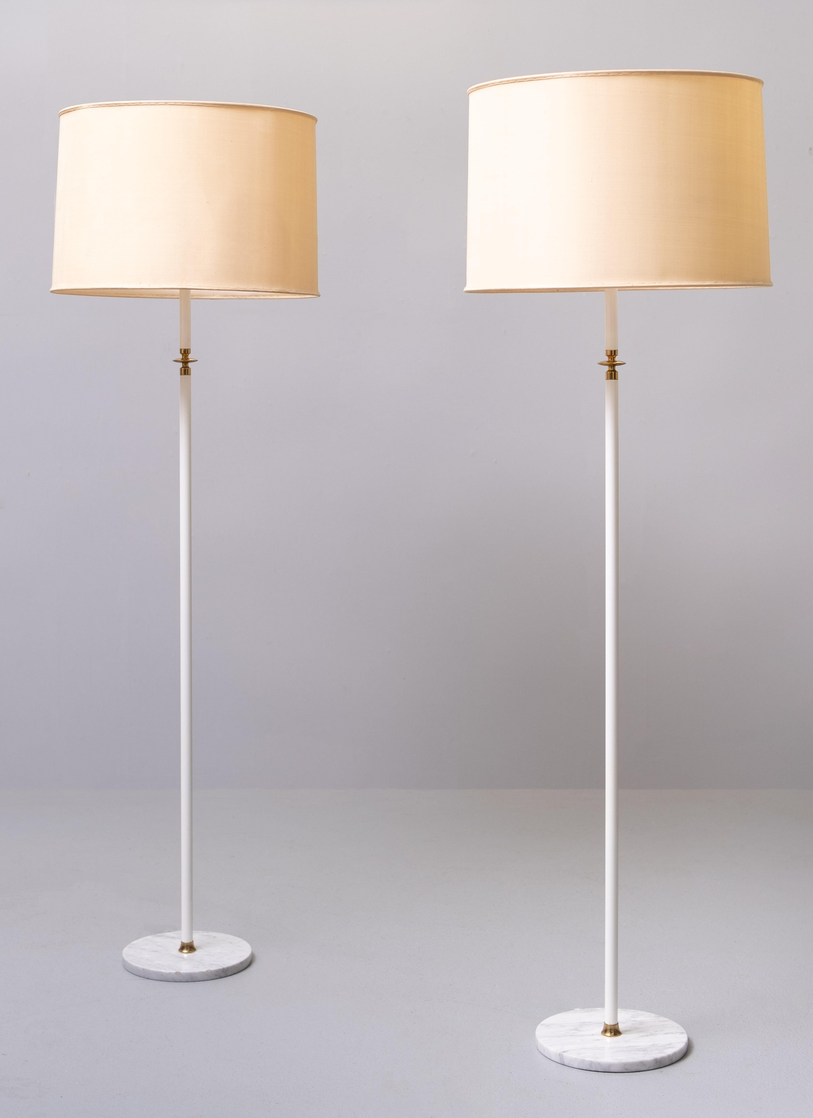 Stunning pair of Floor lamps , all the characteristics of a Arredoluce 
floor lamps .white Enameled upright .Carrara marble base . Brass details .
signed ''Made Italy'' Three large E27 bulbs needed .
can be switch separately .   Super rare and
